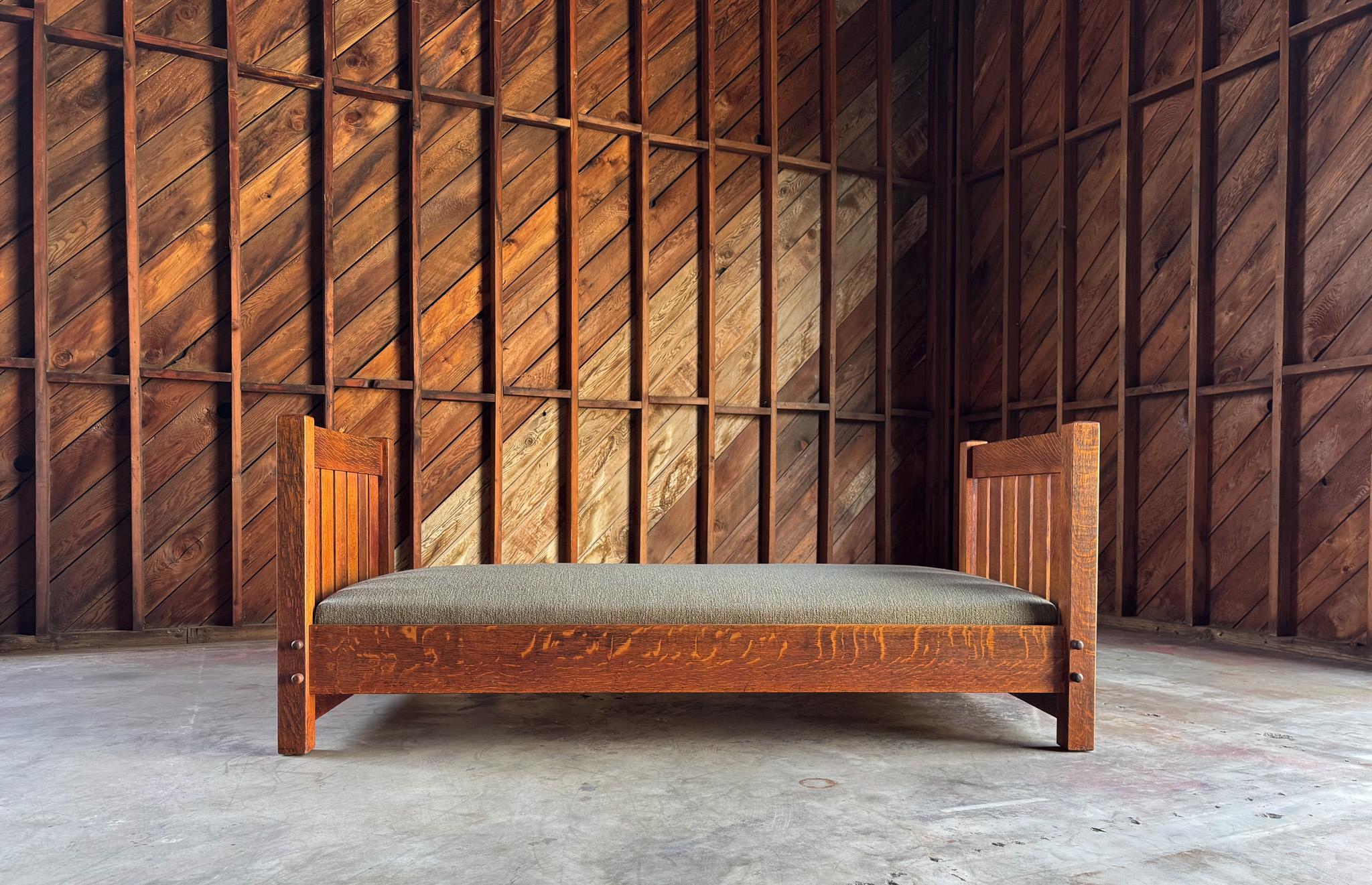 Early Gustav Stickley Knock Down Slatted Daybed Model #220, United States, c.1910.  Beautiful quarter sawn oak frame.  Updated upholstery.
