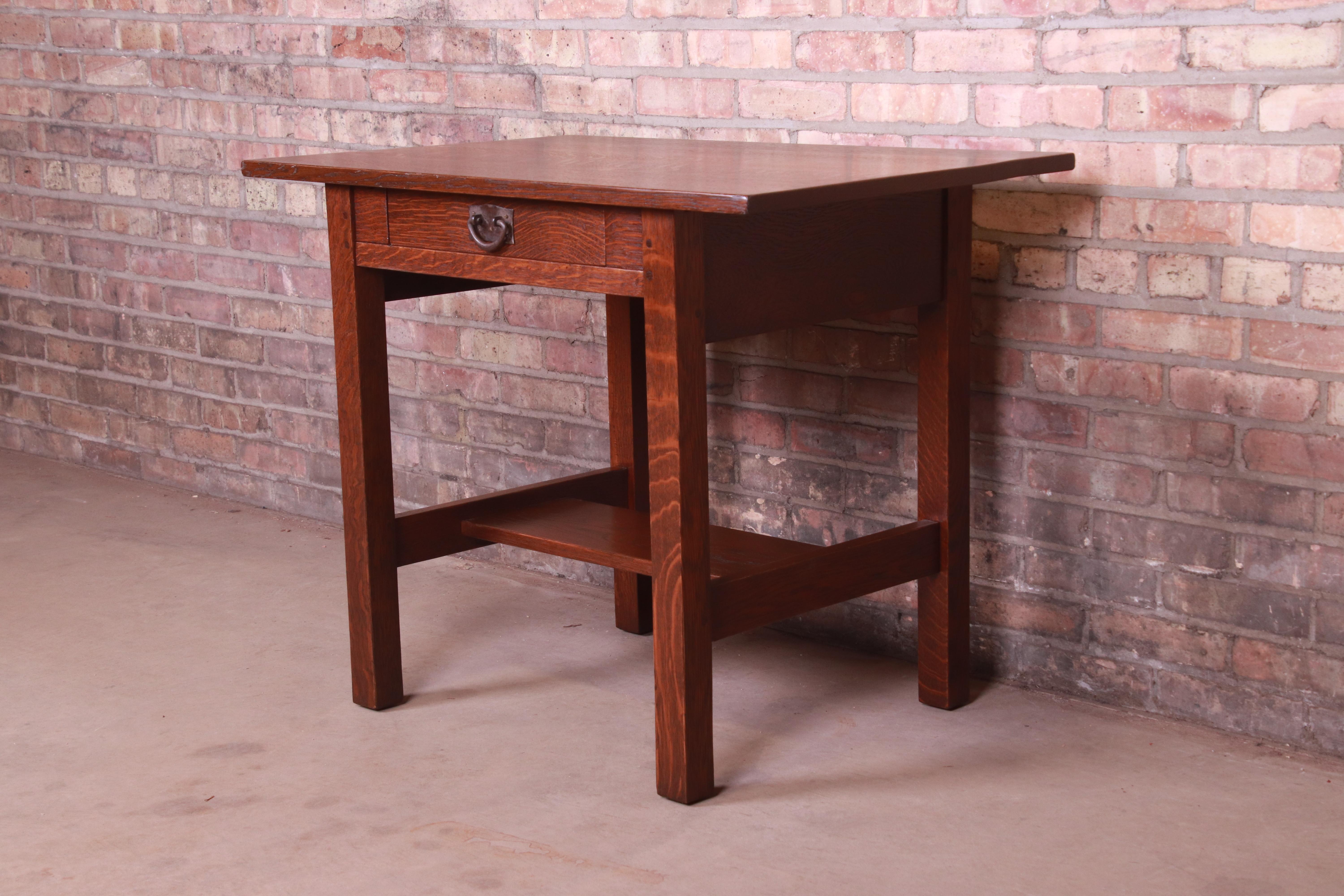 A rare and exceptional antique Mission oak Arts & Crafts writing desk or library table.

By Gustav Stickley (original label present),

USA, circa 1900

Solid quarter sawn oak, with original copper hardware.

Measures: 36