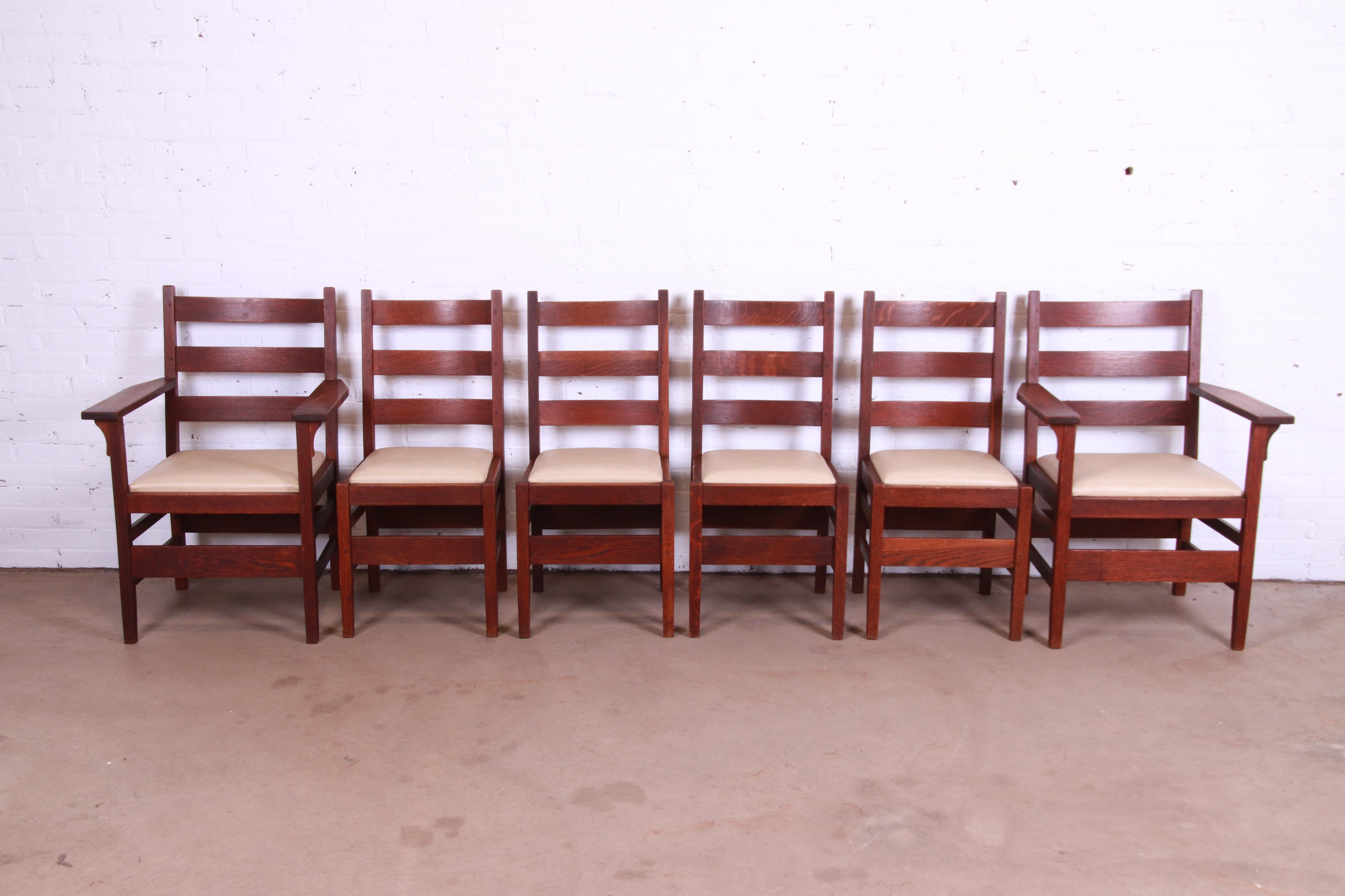 A gorgeous set of six Mission oak Arts & Crafts ladder back dining chairs

By Gustav Stickley

USA, Circa 1900

Solid quarter sawn oak frames, with tan leather upholstered seats.

Measures:
Side chairs - 17