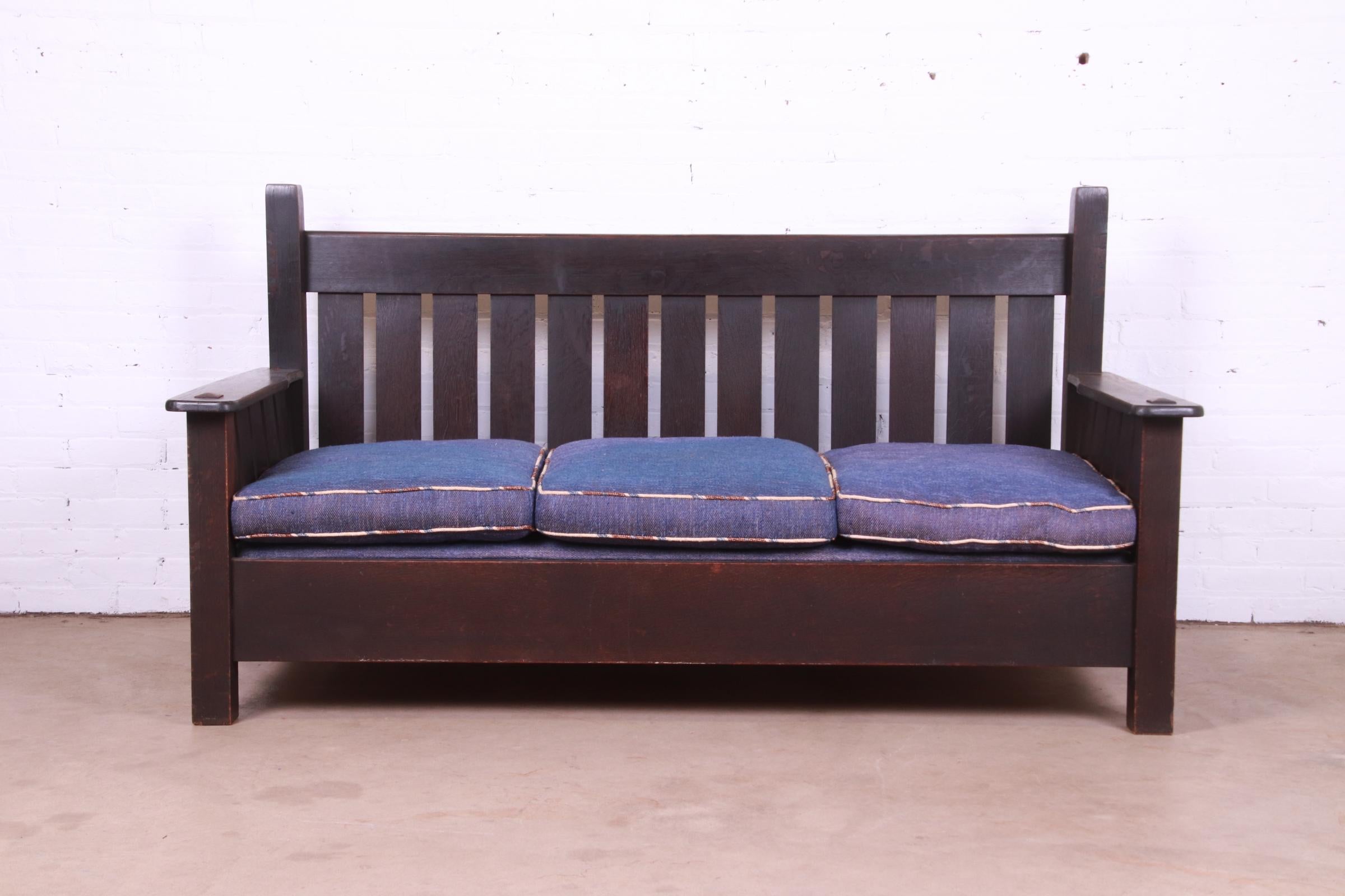 A rare and exceptional Mission or Arts & Crafts settle sofa

By Gustav Stickley (signed with original early label)

Eastwood, NY, Circa 1900

Solid quartersawn oak, with upholstered seat and back cushions.

Measures: 70.75