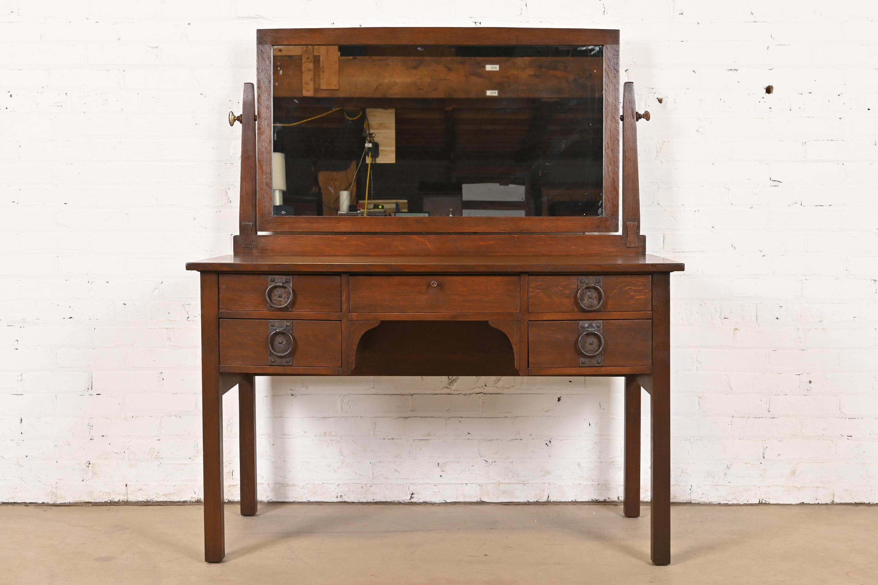 A rare and exceptional antique Mission or Arts & Crafts period vanity or dressing table with mirror

By Gustav Stickley

USA, Circa 1912

Quarter sawn oak, with original swing mirror, and original hammered copper hardware.

Measures: 48