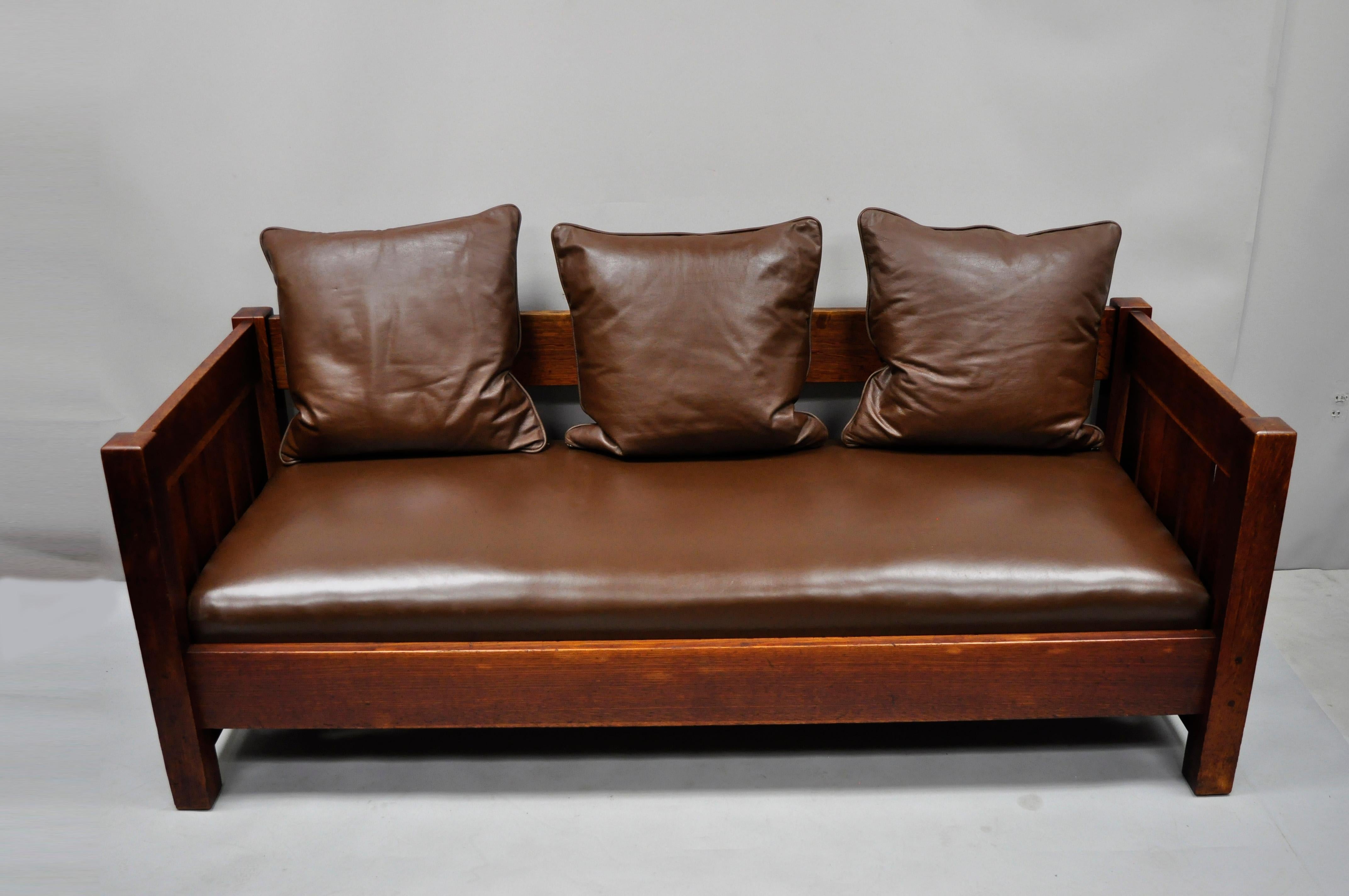 Gustav Stickley settle #225 even arm brown leather Mission oak Arts & Crafts. Item features brown leather spring seat cushion, leather pillows, model #225, five vertical slats, solid wood construction, beautiful woodgrain, original stamp, very nice