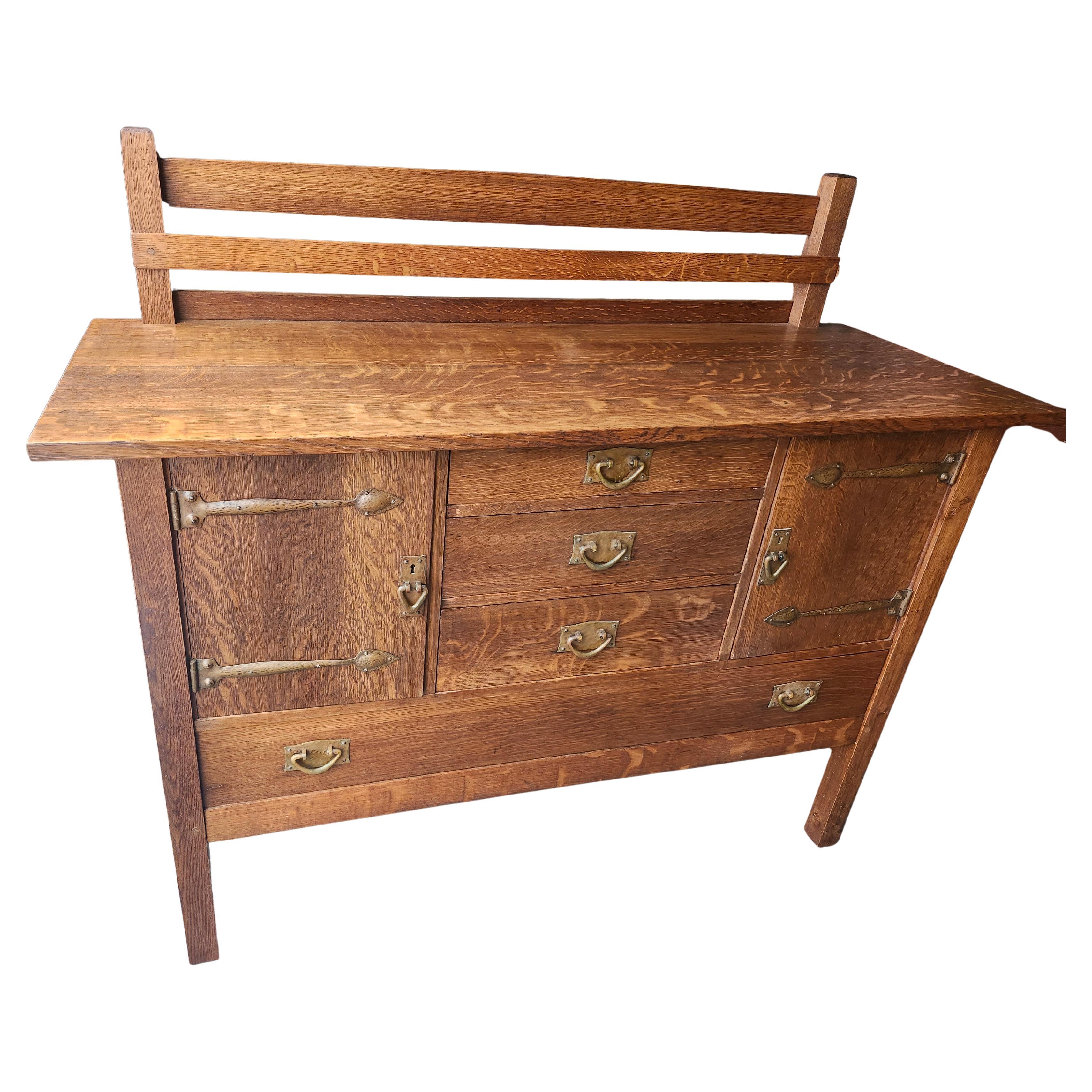 Spectacular early (1905)  Gustav Stickley mission oak arts & crafts sideboard with the most desirable hardware, bronze strap hinges & door , drawer pulls. All hand hammered exclusively by the premier of the Stickleys, Gustav. In excellent antique