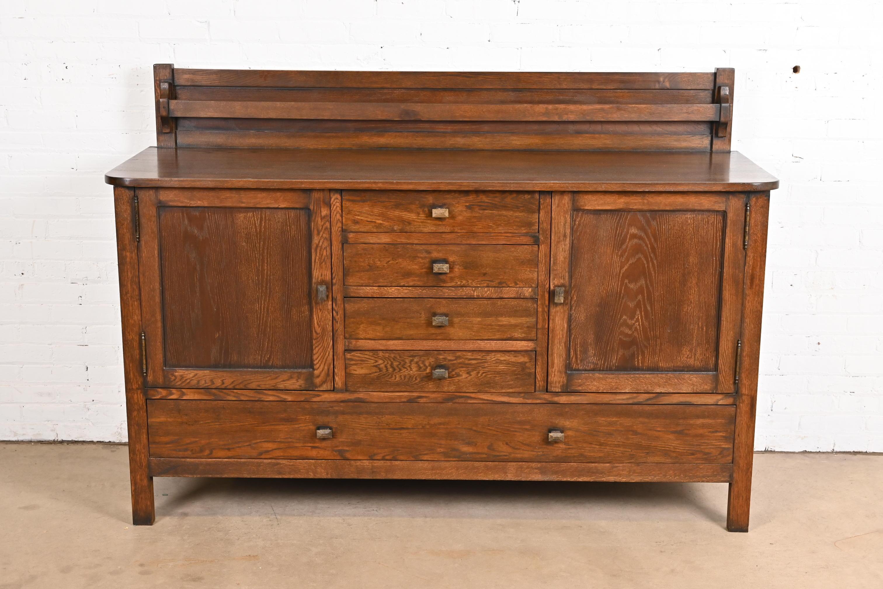 A gorgeous Mission or Arts & Crafts oak sideboard, credenza, or bar cabinet with plate rack

In the manner of Gustav Stickley

USA, Circa Late 20th Century

Measures: 71