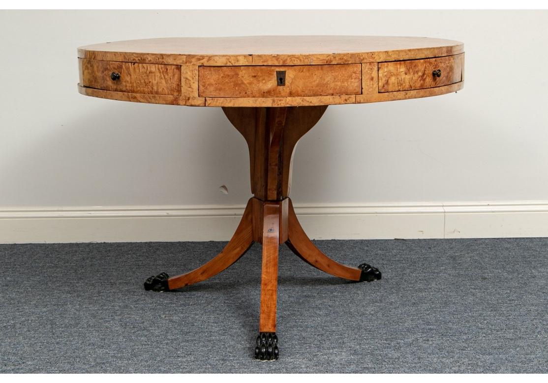 A rare and extraordinary antique center table in all original condition with phenomenal wood grain, great proportions and fine workmanship.
The frieze with four drawers with escutcheons alternating with four pullout / pull-out triangular drawers