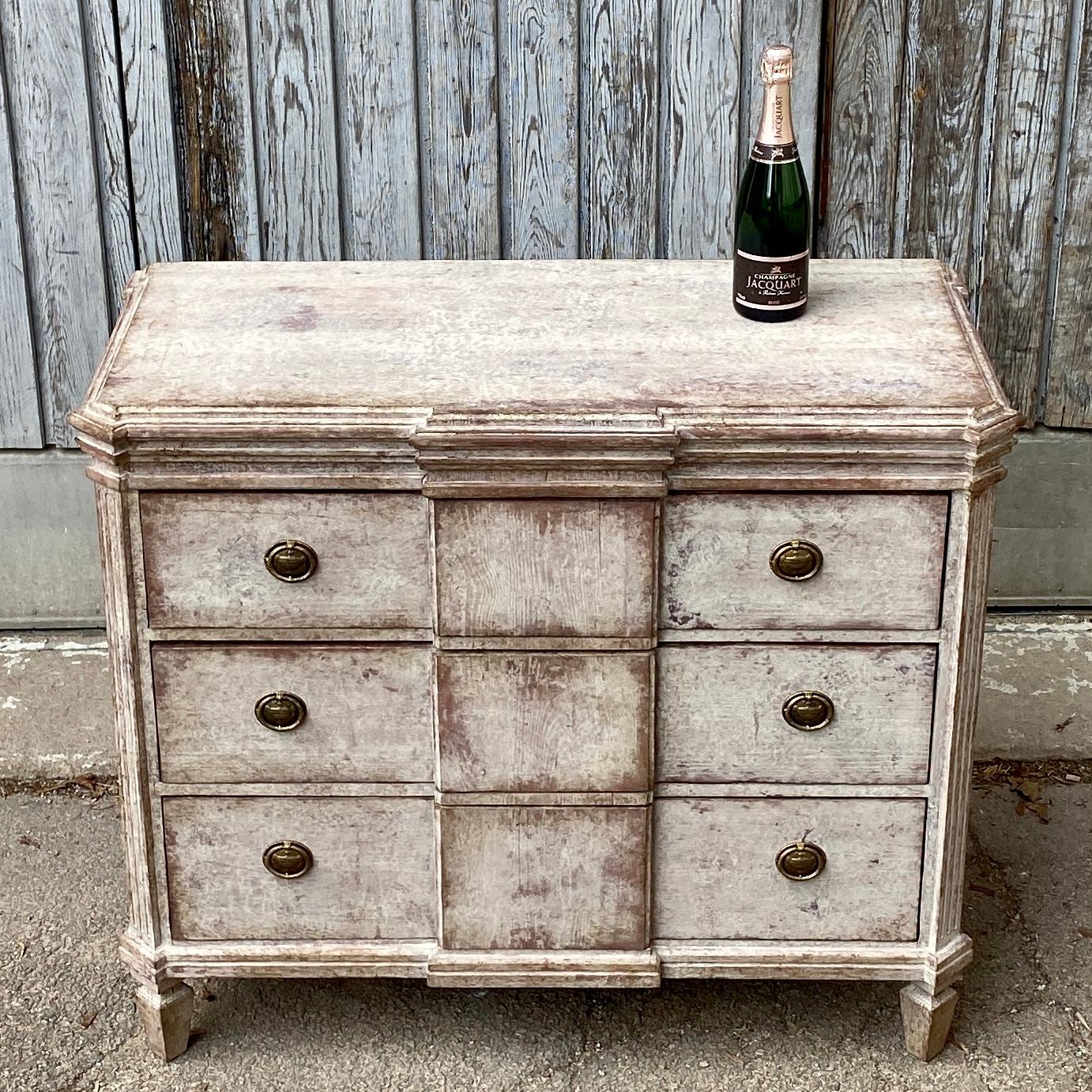 Late Swedish 19th century painted chest of drawers. This 3 drawer dresser has a charming break front style with the original brass hardware.