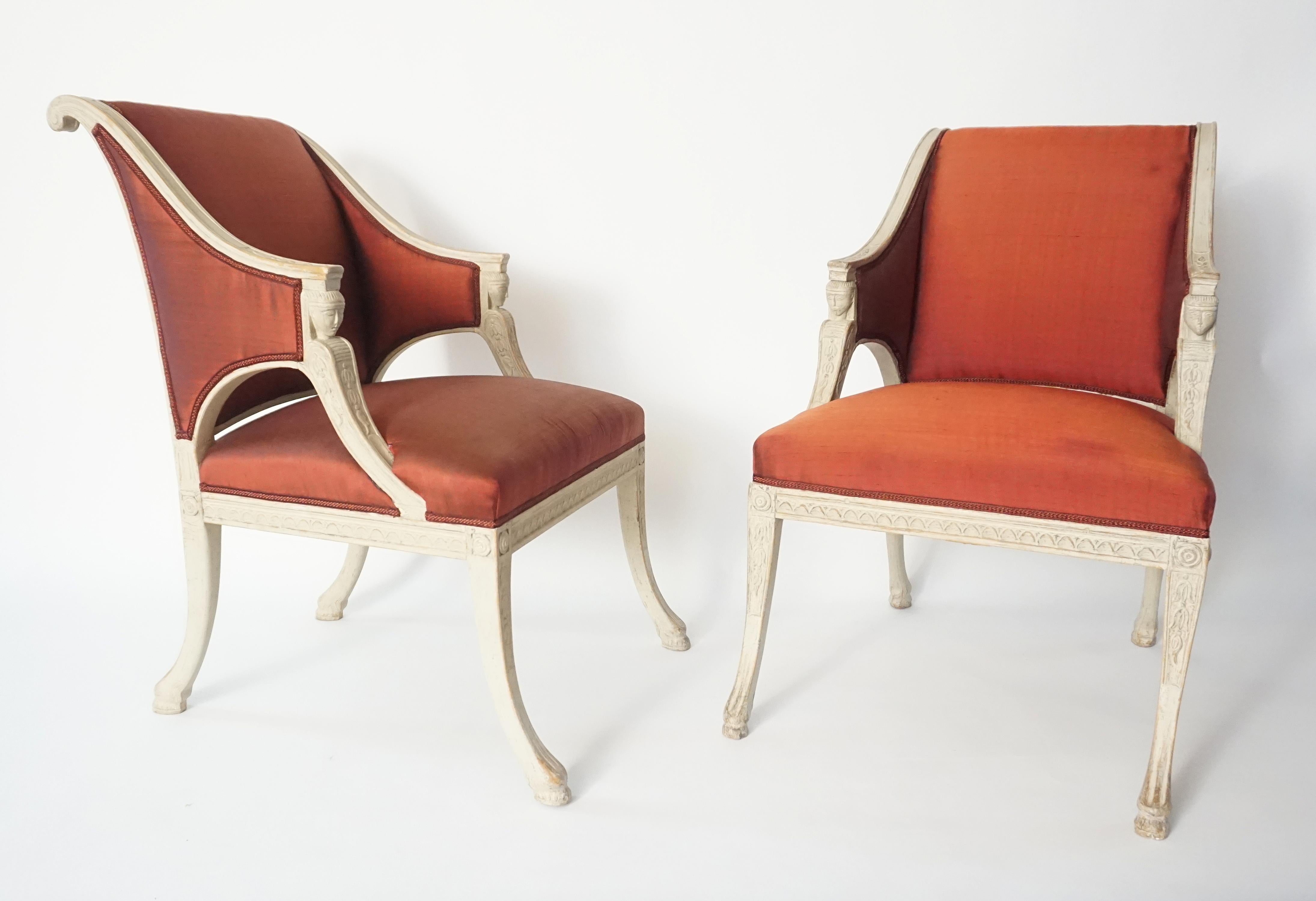 Rare and exceptional pair of Swedish Gustavian period and style armchairs by Royal Court appointed chair-maker Ephraim Ståhl (b. 1768 - d. 1820) in original paint; the scrolled and upholstered arched backs issuing abbreviated sloping arms ending in