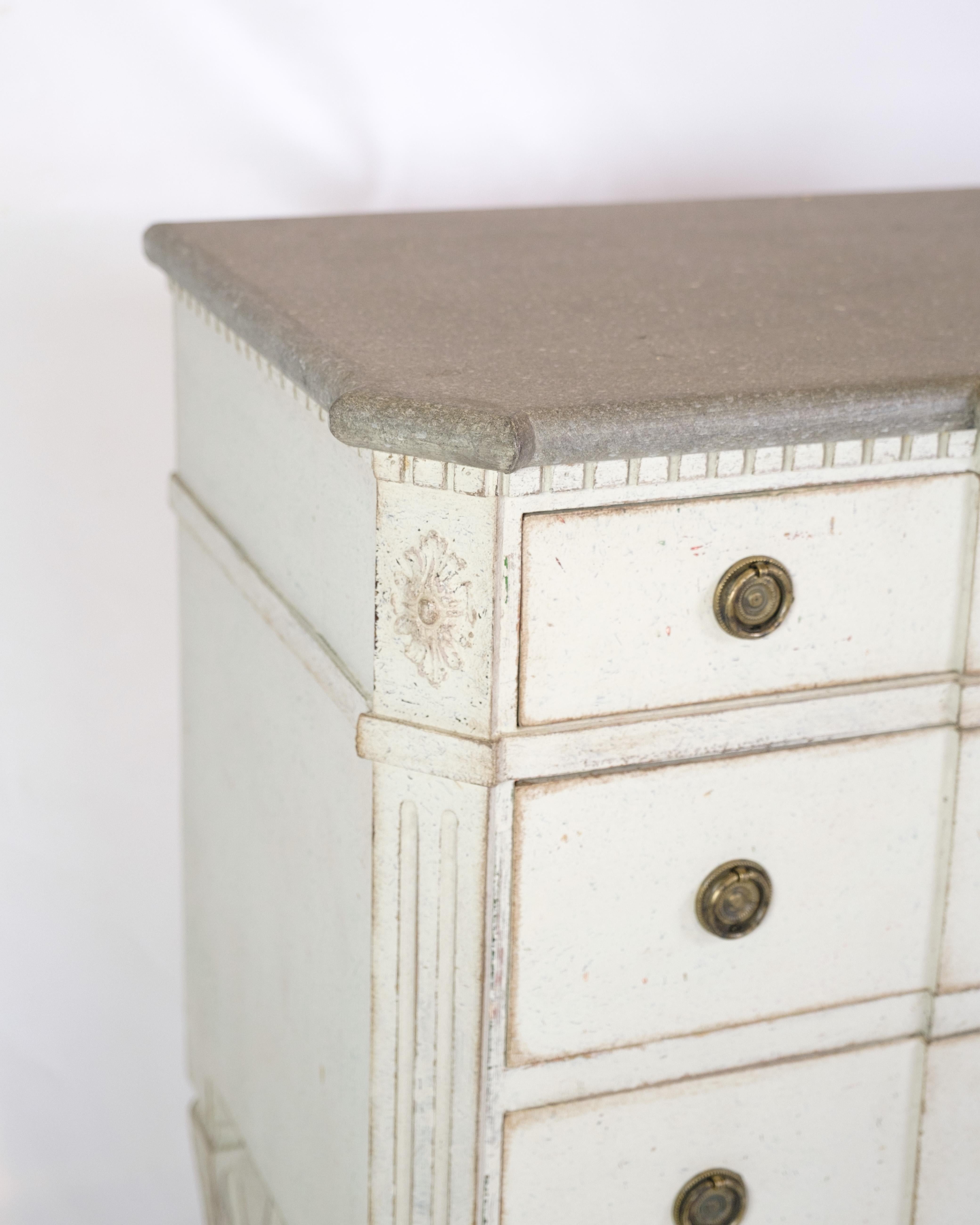 Gustavian chest of drawers from the 1840s with three drawers, painted grey in a classic style. Top made of marbled wood, giving an elegant expression. Swedish origin with period carvings and details. An authentic piece of furniture with both