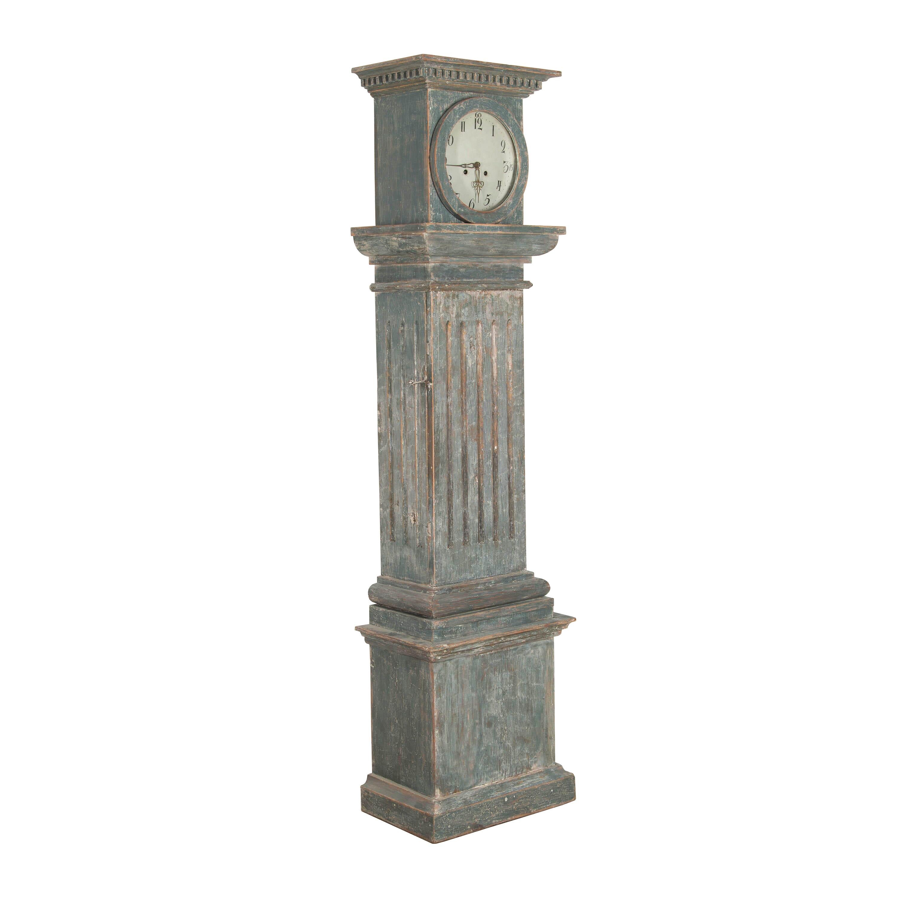 Period Gustavian column clock from Dalarna.
This carved wooden clock retains its original blue paintwork which has been revealed after scraping. It has an unusual design that resembles a classic English country house clock rather than a Swedish