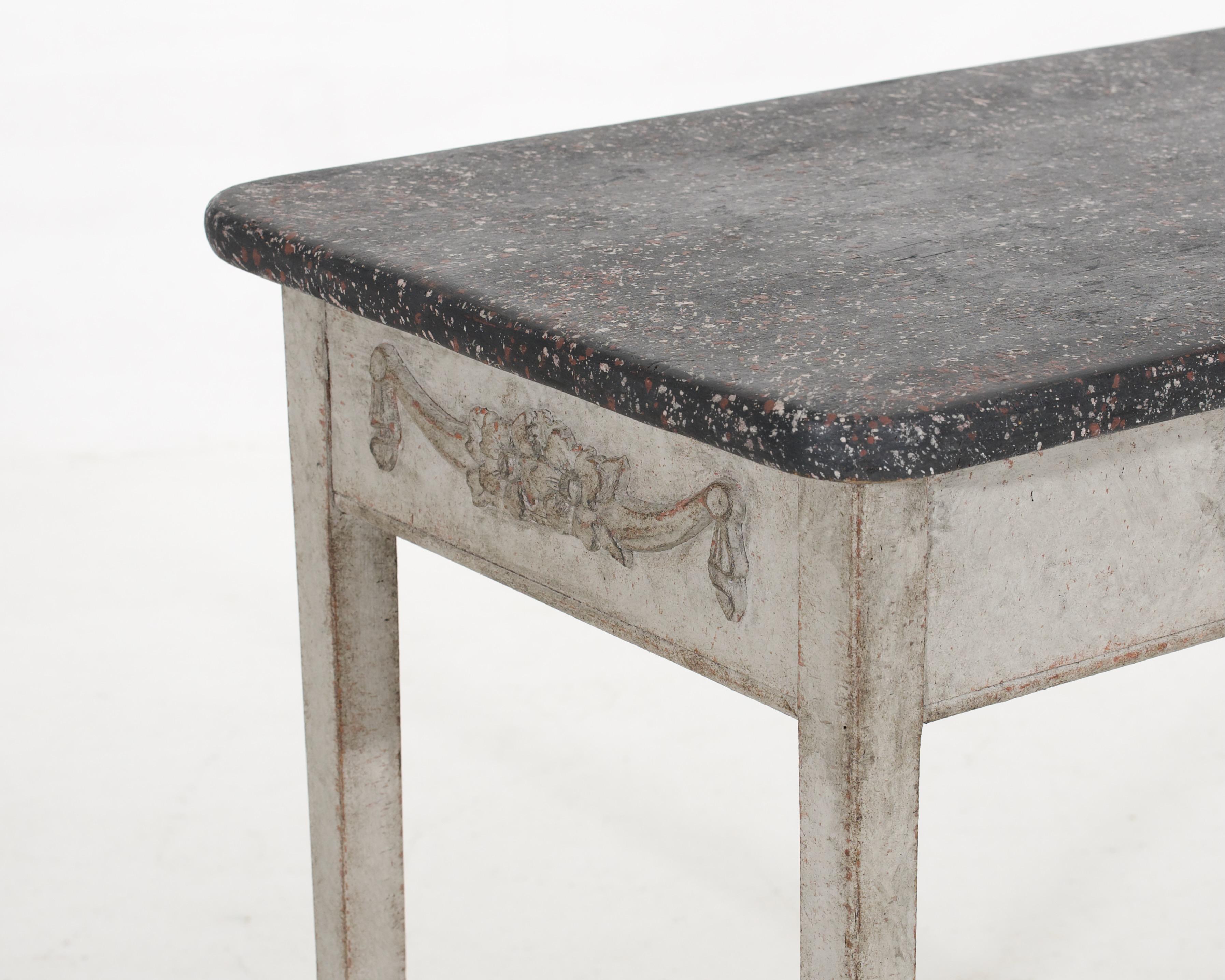This 1810 Gustavian console table features a finely detailed drawer and faux marble-painted top.