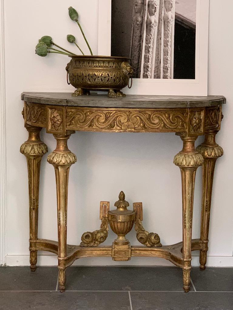 A Swedish console table from the Gustavian period, from about 1780. 

The table is a high quality piece made in Stockholm and has exquisite carvings in gulitwood. The top is original grey limestone. Leaf sheated, fluted legs and a foot cross with