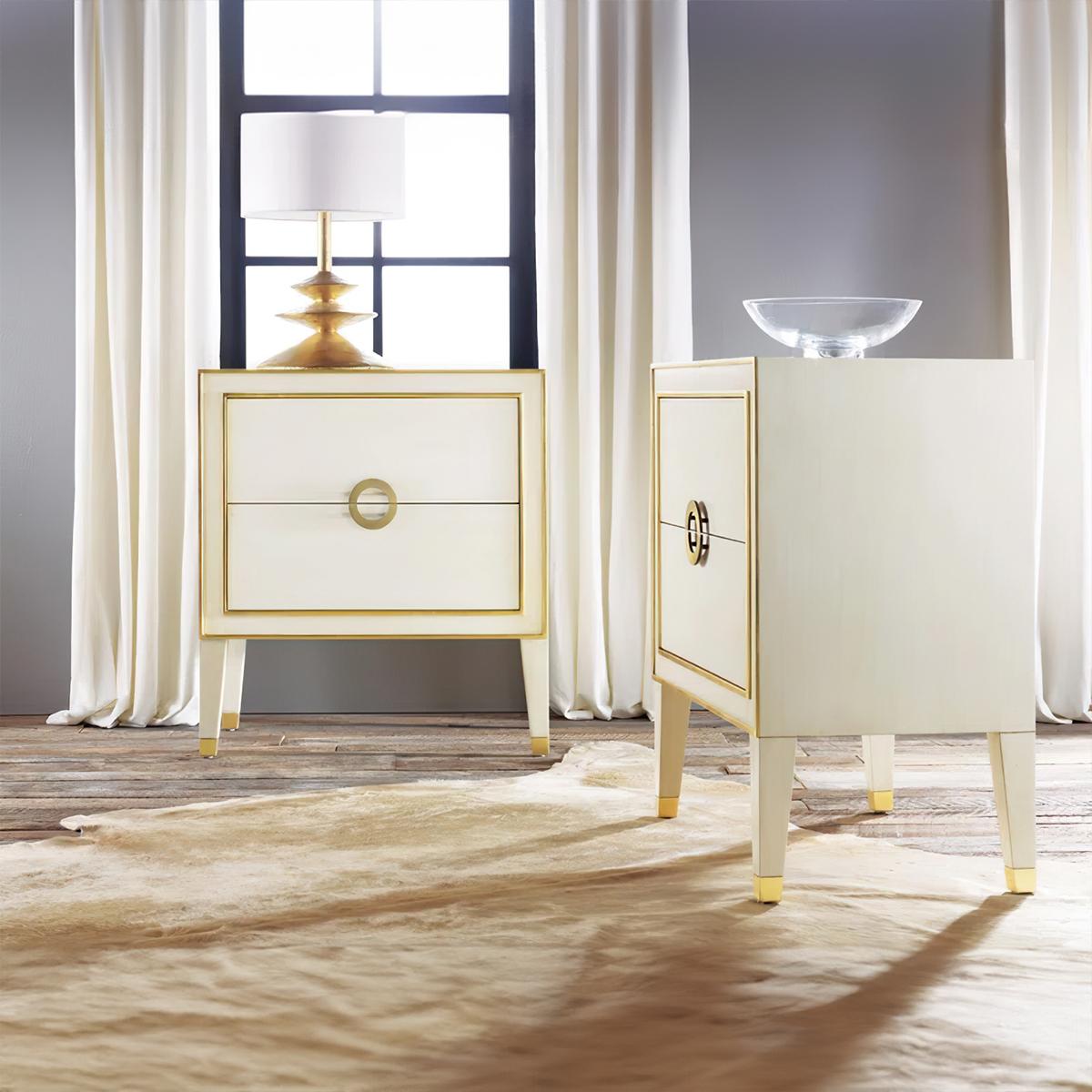 This beautifully crafted Neo Classic Swedish-inspired nightstand features a soft cream finish, accented with delicate gold trim that highlights its refined design.

The two spacious drawers are adorned with a unique circular solid brass hardware,