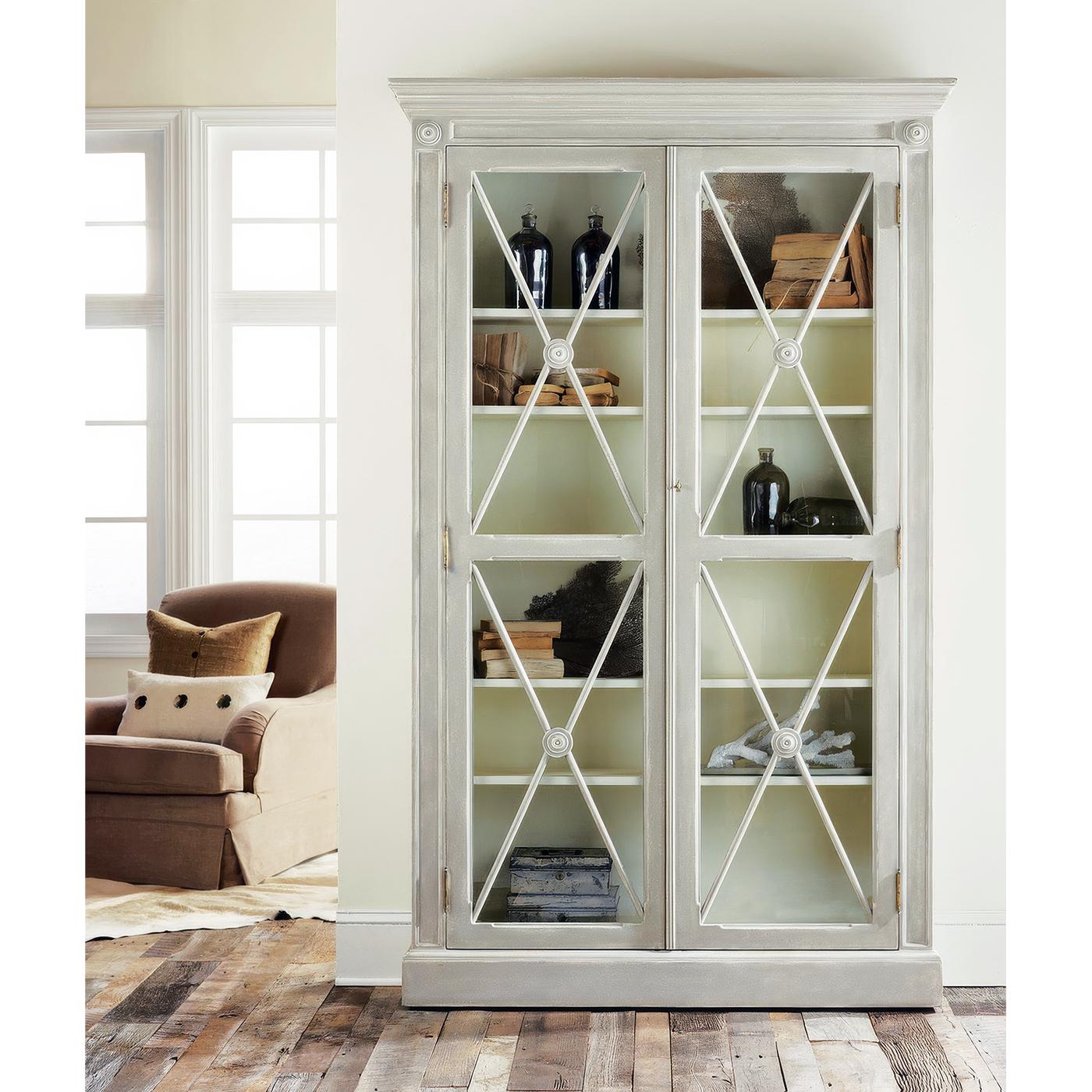Its hand-painted antique grey distressed finish lends an air of antiquity. Designed to showcase your most treasured collections, this bookcase features four adjustable shelves and a fixed middle shelf, offering ample space for curated displays.