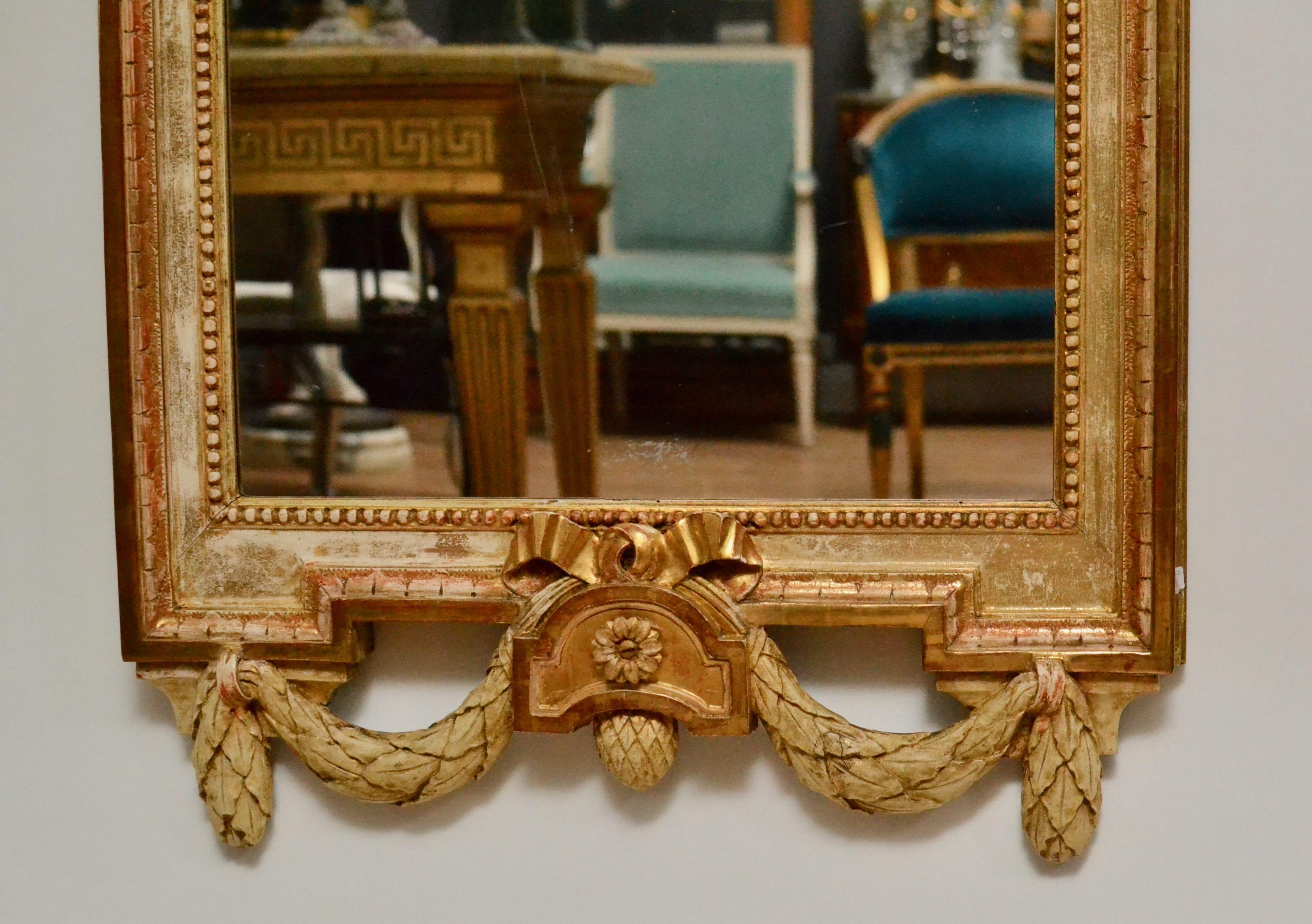 Gustavian wood carved giltwood mirror by Johan åkerblad (master 1758-1799). Signed IÅ and AÖB, Anders Öberg (Working with Åkerblad 1781-1799. 56. Stockholm 1758-1799). Stamped with the mirror makers guild STOCKHOLM and date 1781. Unusual model with
