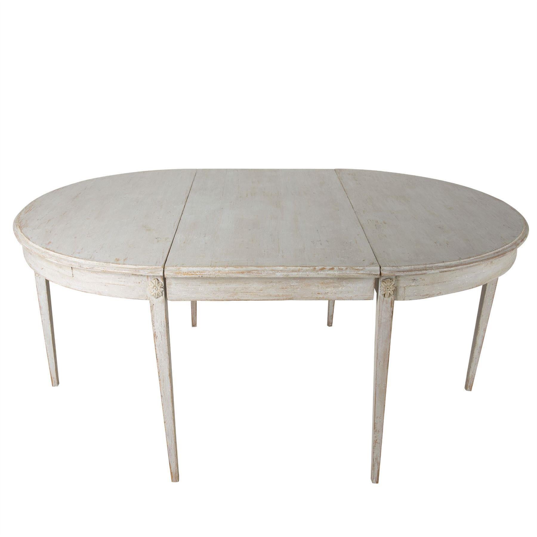 A late Gustavian period extending dining table circa 1800s in later paint, with two centre leaves. Minimum width is 118cm with both D ends as a round table, extending to 178 cm with one leave and then to 238 cm with two leaves inserted, Swedish.