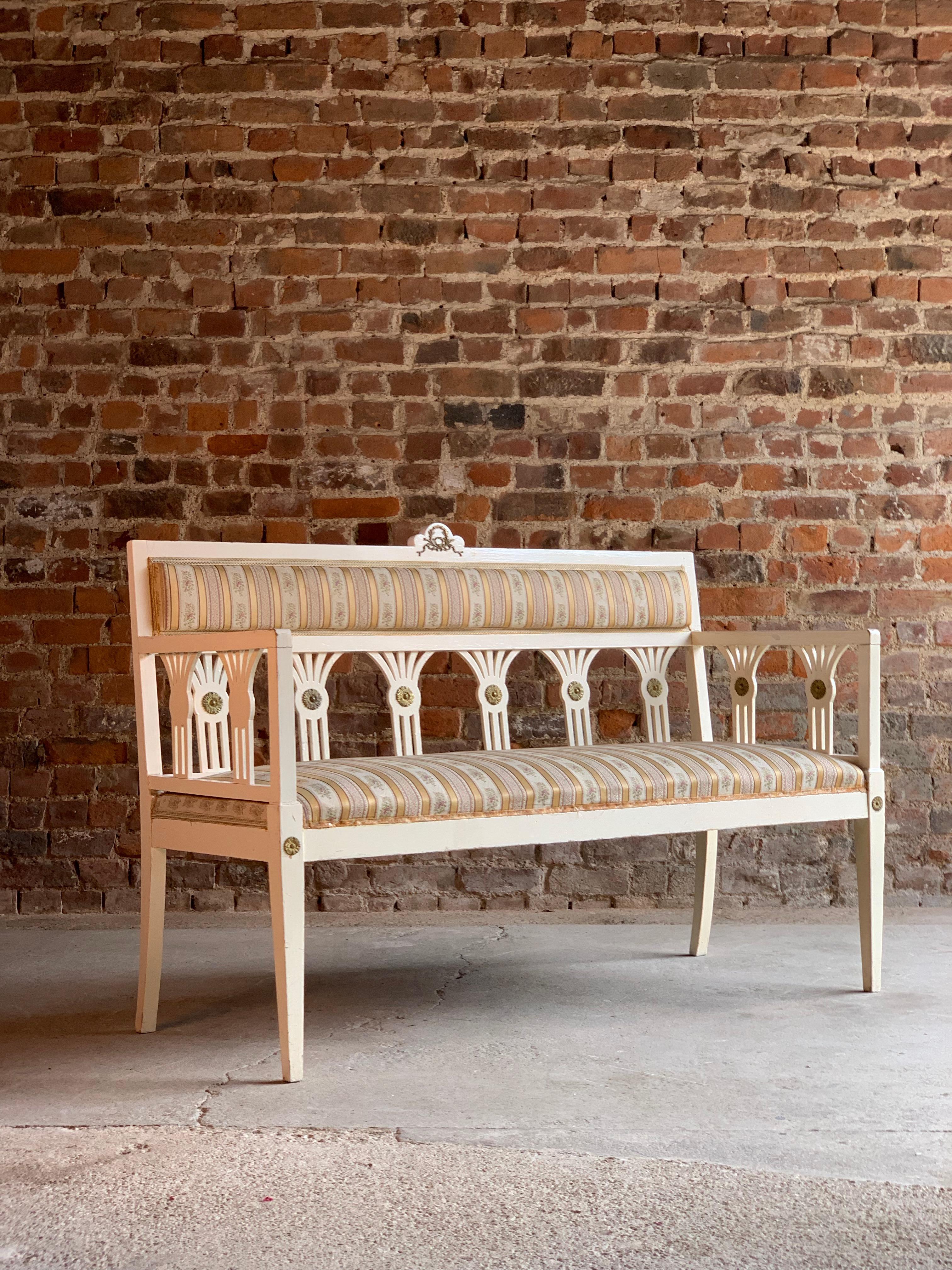 Gustavian salon suite sofa and two chairs, Sweden, circa 1930

Gustavian salon suite sofa and two chairs, Sweden, circa 1930, the two-seat sofa with striped silk fabric with two matching chairs, the wooden frames finished in white with gilded