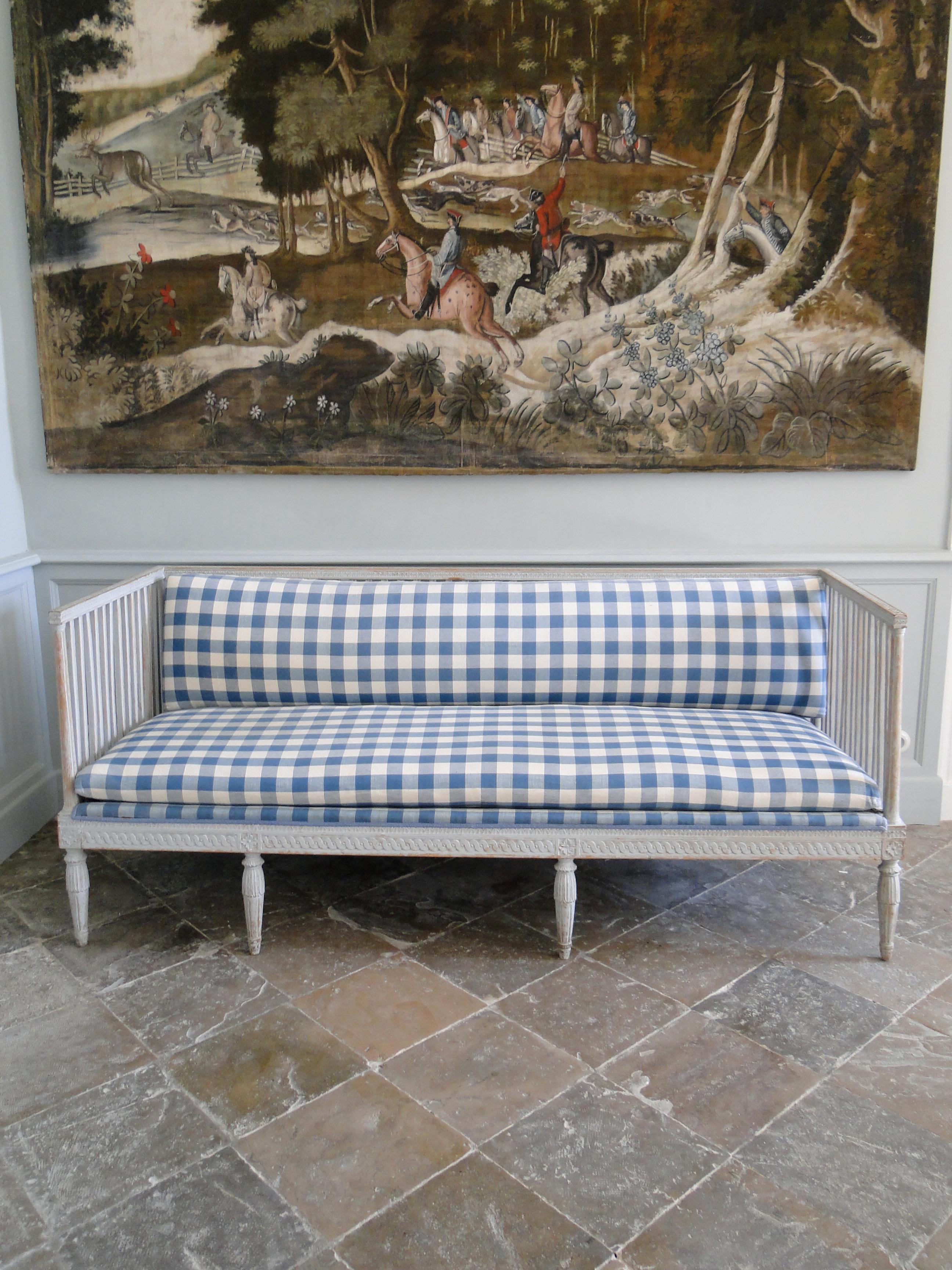 Gustavian sofa, 19th century painted in light grey with carved decor later upholstered with two loose cushions, in a very good shape.