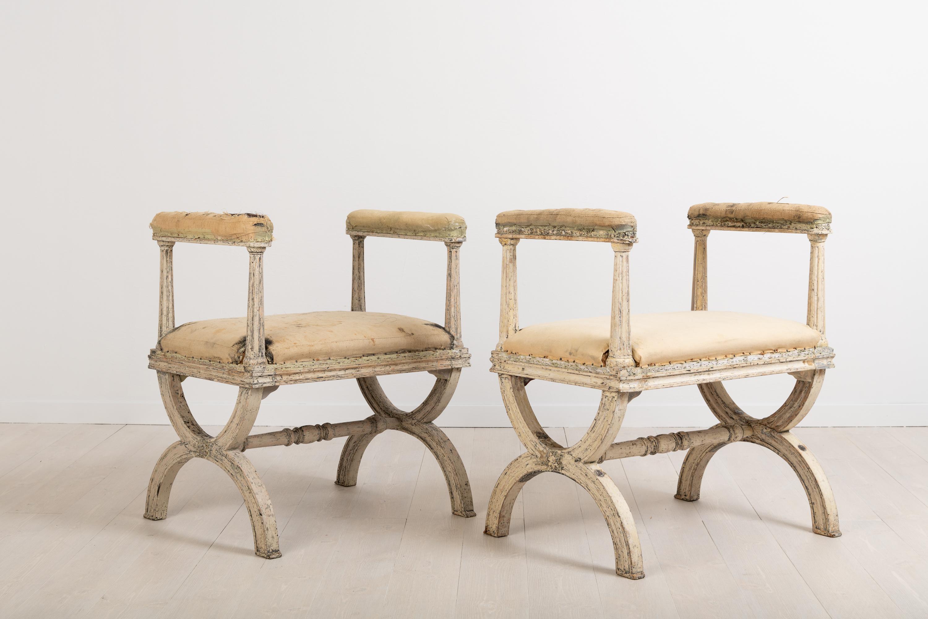 Gustavian stools or banquets by Ephraim Ståhl manufactured in Stockholm. The stools are signed with a cold stamp ES for Ephraim Ståhl, one of Swedens best chairs makers during the gustavian period. Dry scarped to the distressed original paint. There