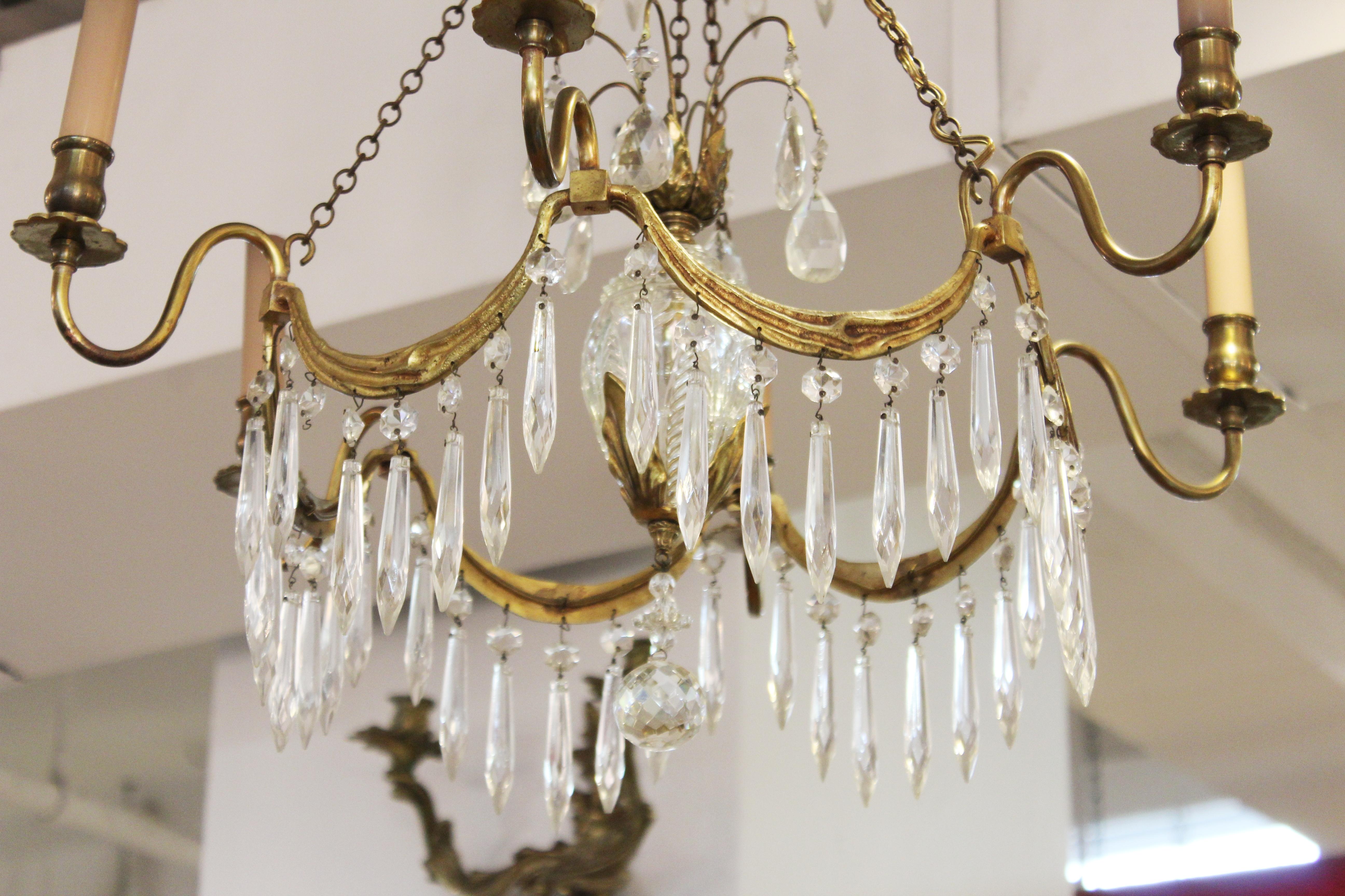 Gustavian style diminutive chandelier with brass frame and crystal droplets. The piece has six light arms. In great vintage condition with age-appropriate wear and use.