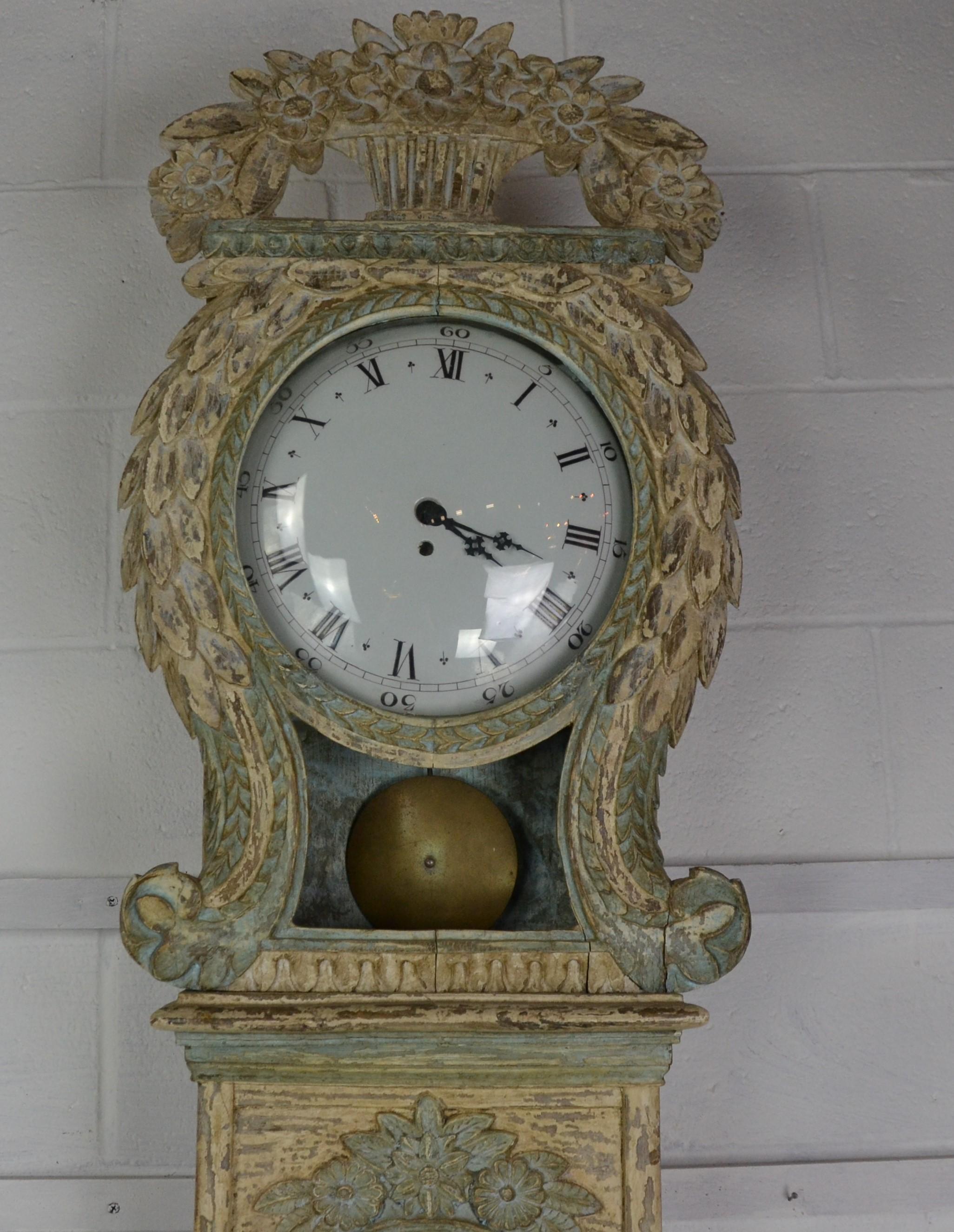 A Gustavian style grandfather clock in it's original paint, mid-20th century, porcelain face with 30 hr movement and faux pendulum.