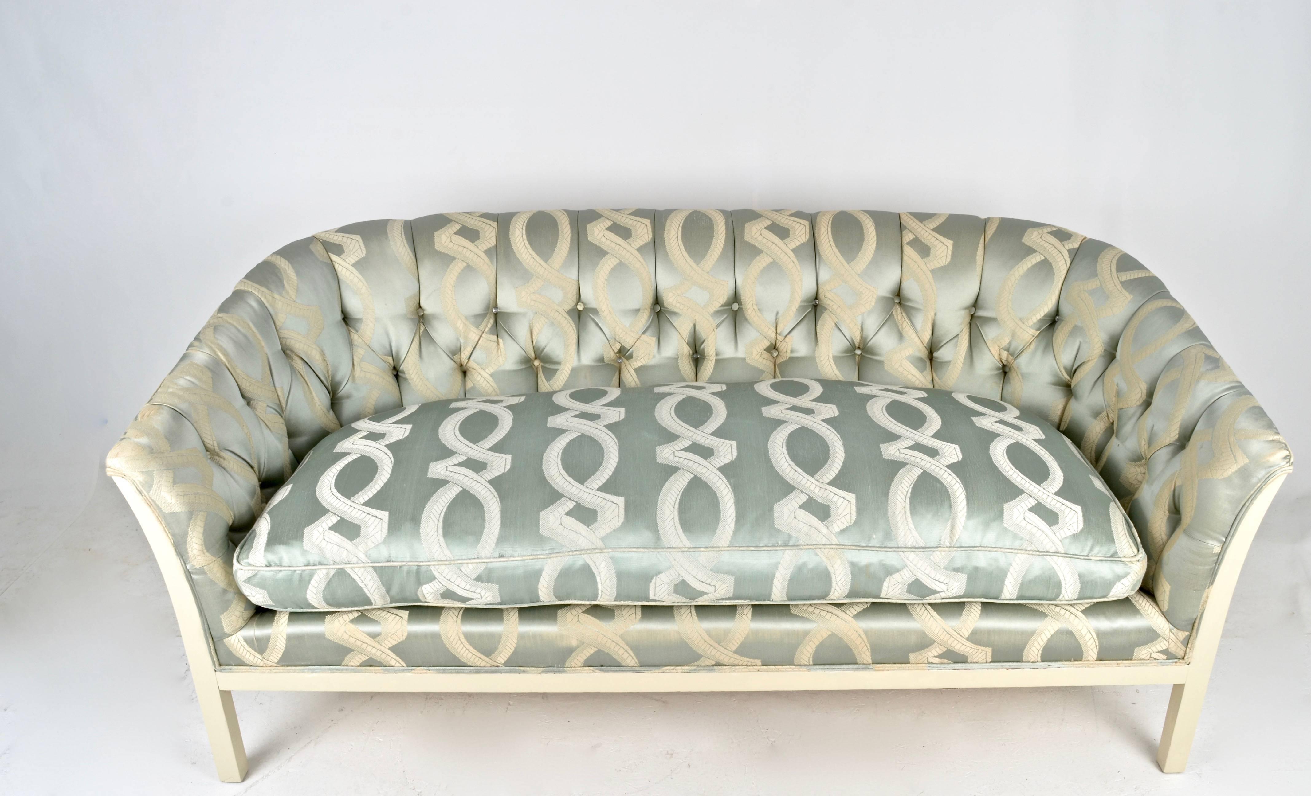 Featuring a tufted back and fine quality all down single cushion, this small sofa combines great lines with comfort. The original silk fabric is quite clean but shown some signs of wear and the tufting is missing covers on a few of the buttons.
