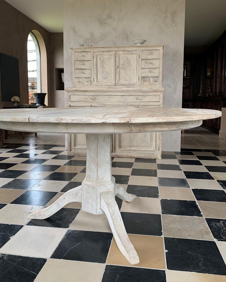 A custom made round table in Gustavian style. Made in old pinewood and patined with milkpaint.