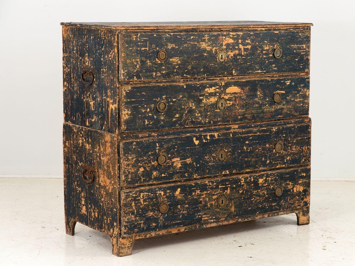 The early 19th-century Swedish Chest on Chest is a captivating and functional piece of furniture. Comprising two sections, each with two spacious drawers, it offers ample storage capacity. The iron handles on the sides of each drawer not only