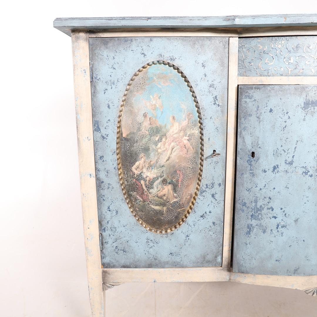 Early 1900s 3 drawers Swedish Gustavian style chest of drawers commode in sky blue paint with later hand-painted detail and stencil work in a classical theme with nymph scene antiqued later prints on both doors. It is decorated with beaded detail