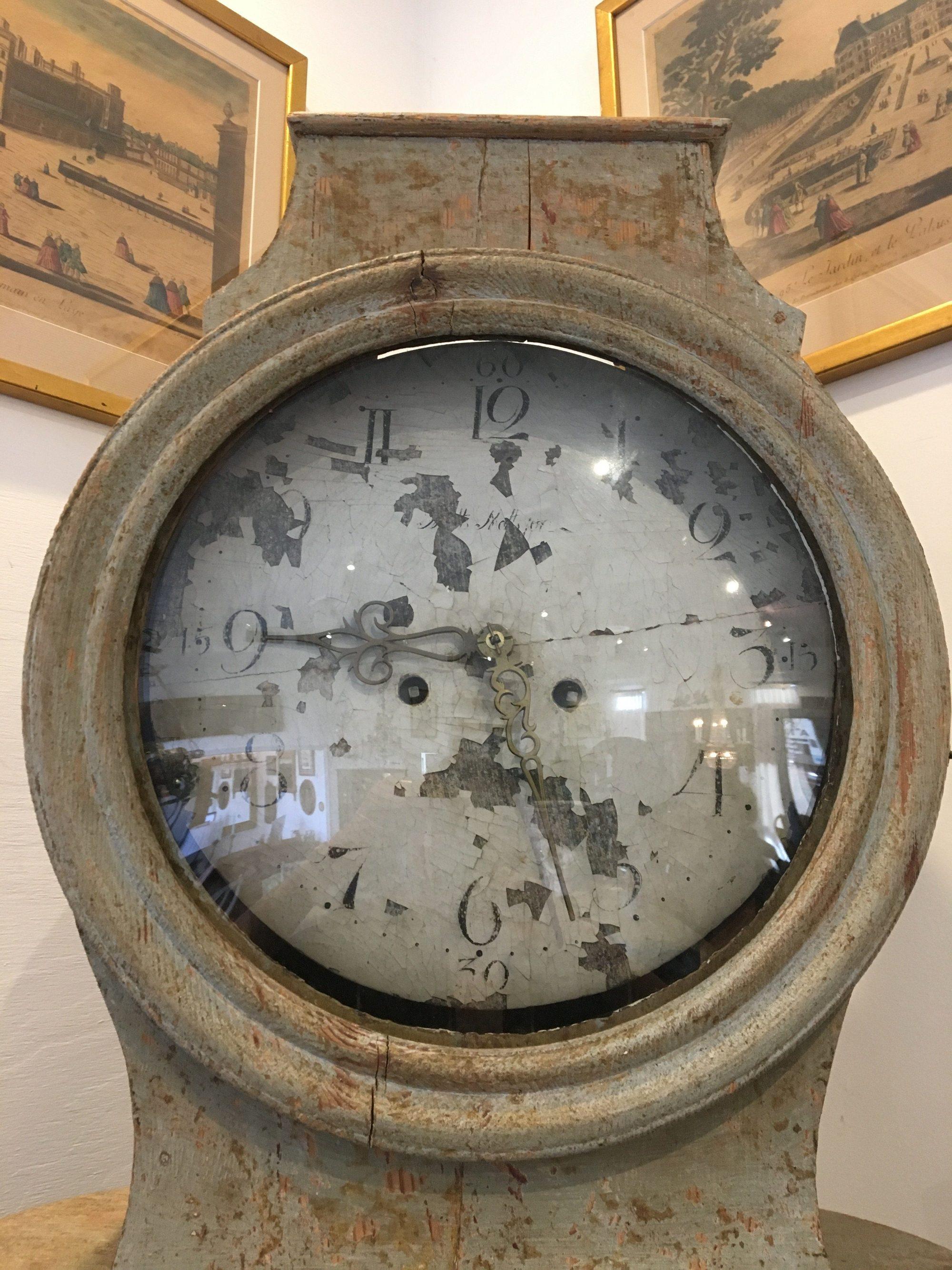 Gustavian Swedish columnar clock, 18th century, original grey-green-white paint, works, face. This beautiful and rare form grandfather clock, a variation on the Mora clock. Its column body is comprised of three parts plus the removable works case.