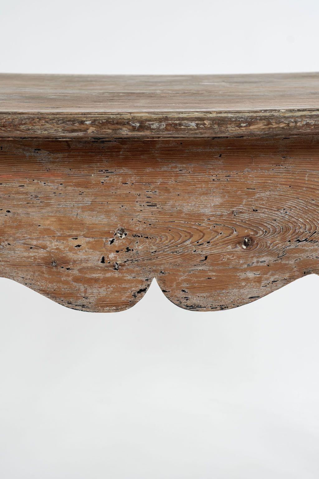 Gustavian Swedish console table, hand-carved in rococo style circa 1740-1760. Mortise and tenon construction. Finish hand-scraped back to early, or original, paint. Bowed-front shaped top and carved scalloped apron raised upon squared cabriole legs.