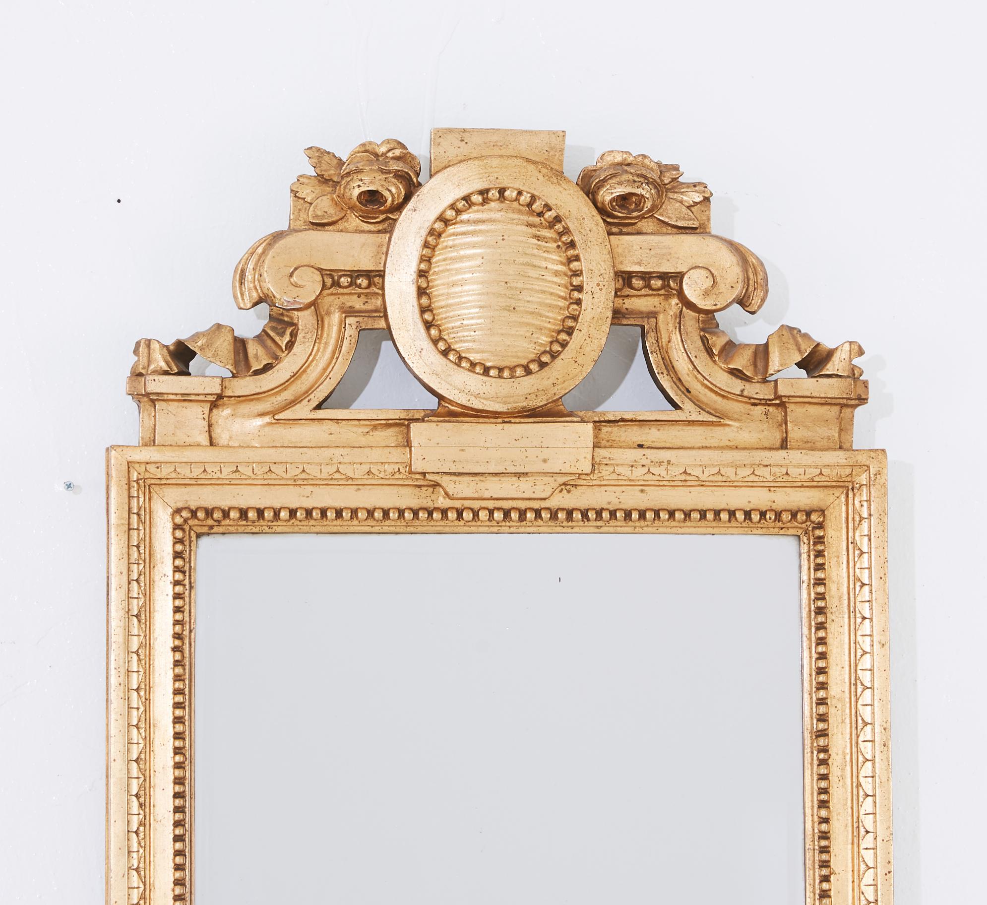 Mirror, Gustavian Stockholm work, signed by Master CGF Carl Gustaf Fyrwald (mirror manufacturer in Stockholm 1776-1825 / 32), carved decor, gilt, approximately 130 x 54 cm.