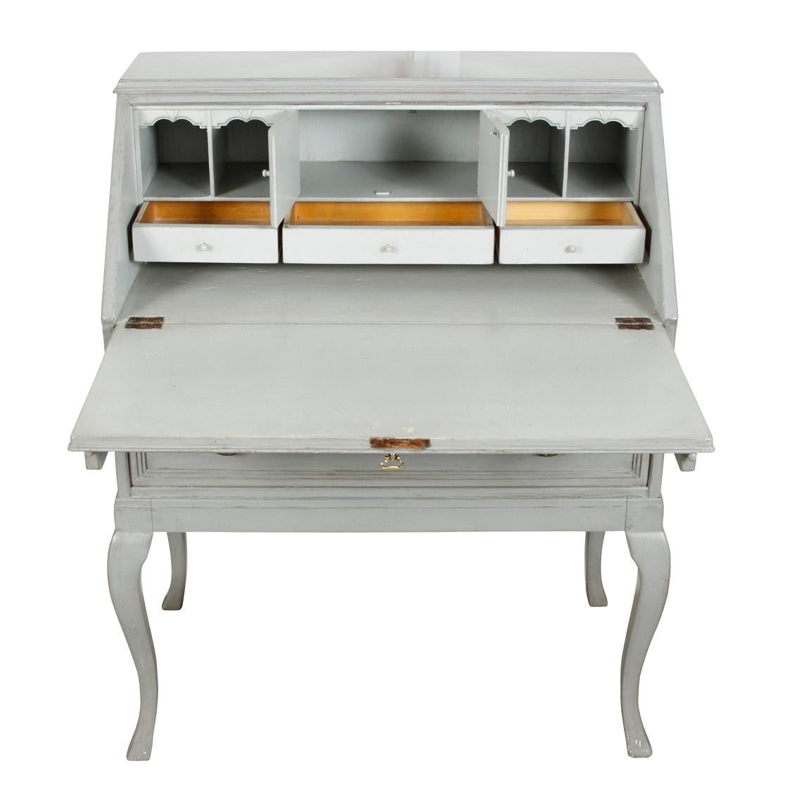 A charming little Gustavian painted slant-top secretary in a lovely bluish gray, featuring an exterior drawer and three small interior drawers below four little storage cubbies, raised on cabriole legs. This little jewel has great style, yet is