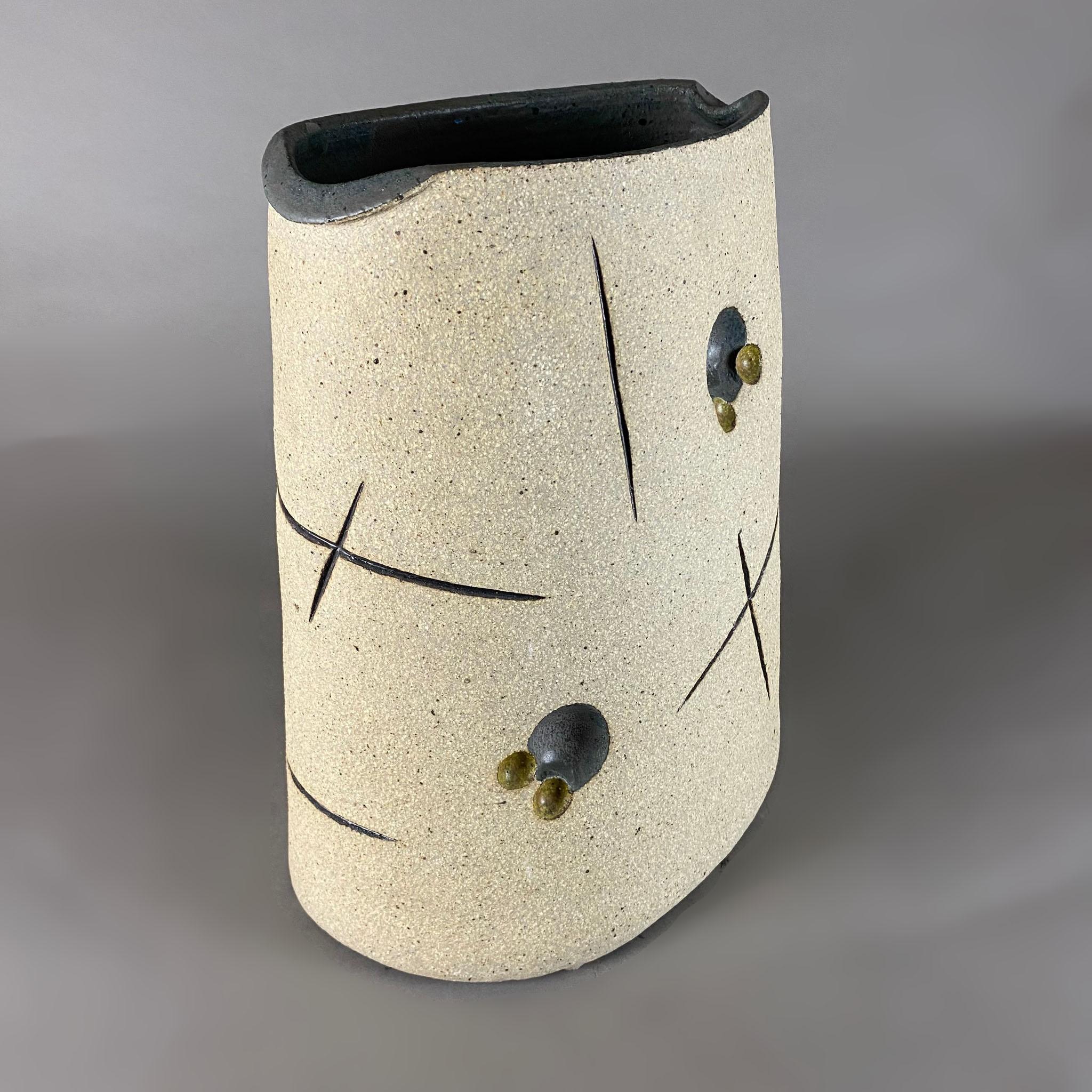 Vase en céramique haute température de Gustavo Pérez. Le vase de forme organique présente un intérieur noir, un vase ovale et différents cercles et 