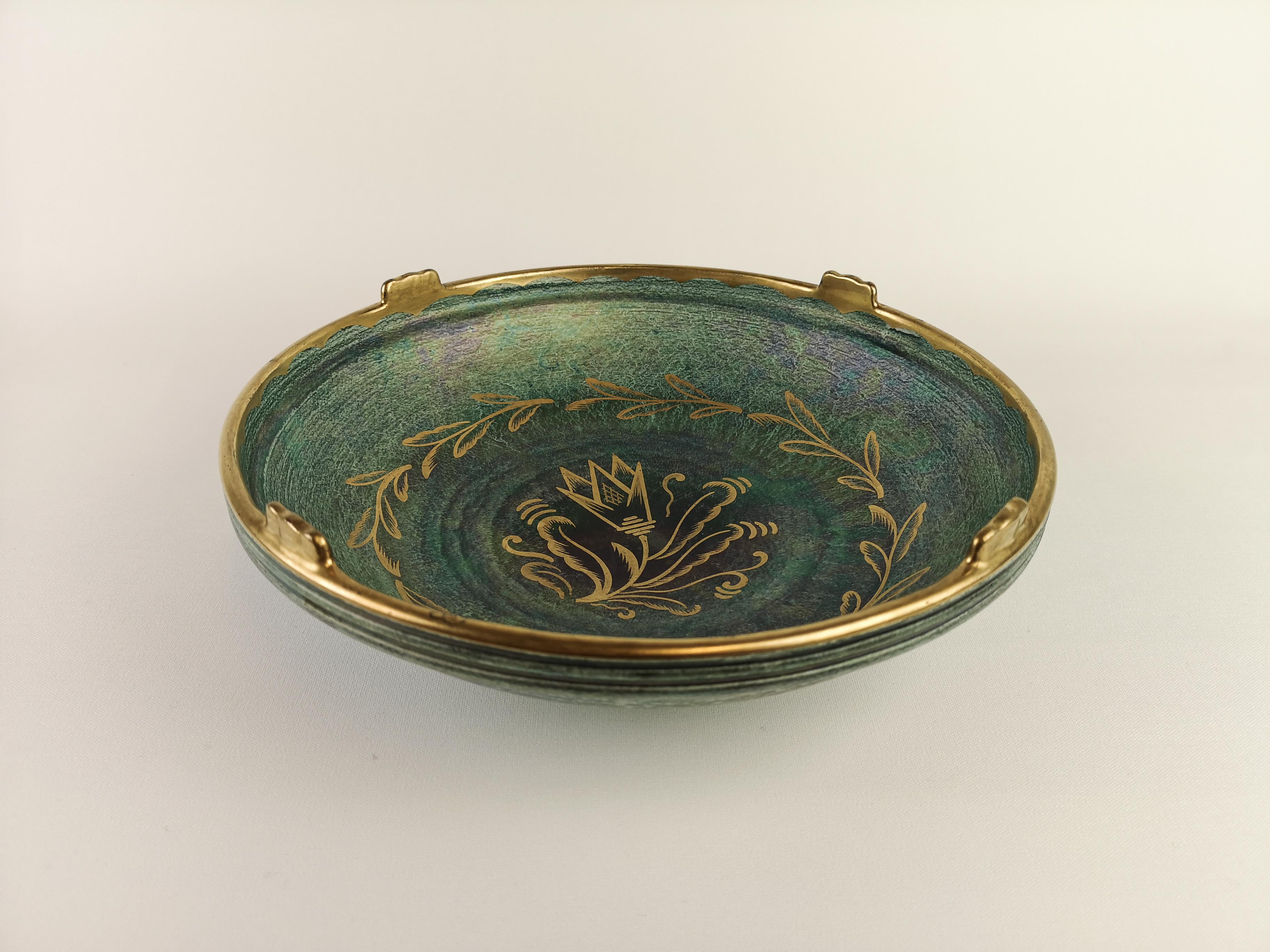 A wonderful bowl created by Josef Ekberg and manufactured by Gustavsberg Sweden in 1920s. Wonderful green glaze with hand painted gold pattern on the bowl. 

On marke on the edge of the bowl otherwise in excellent condition.