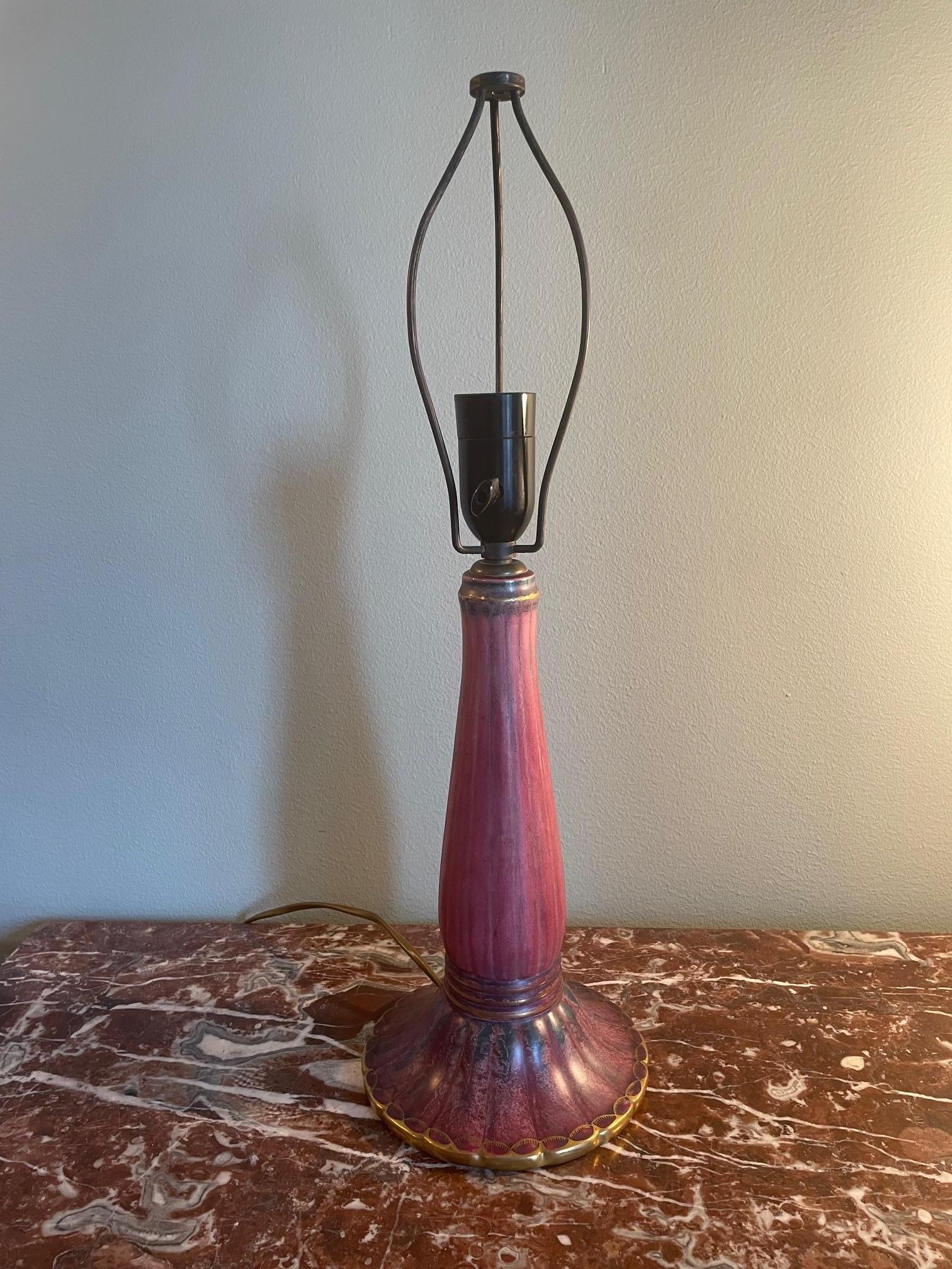 An exquisite Swedish Art Deco table lamp by Josef Ekberg, dated 1928, crafted at the renowned Gustavsberg porcelain factory. The ceramic base features Ekberg’s signature sgraffito technique with deep plum glazing accented by golden highlights,