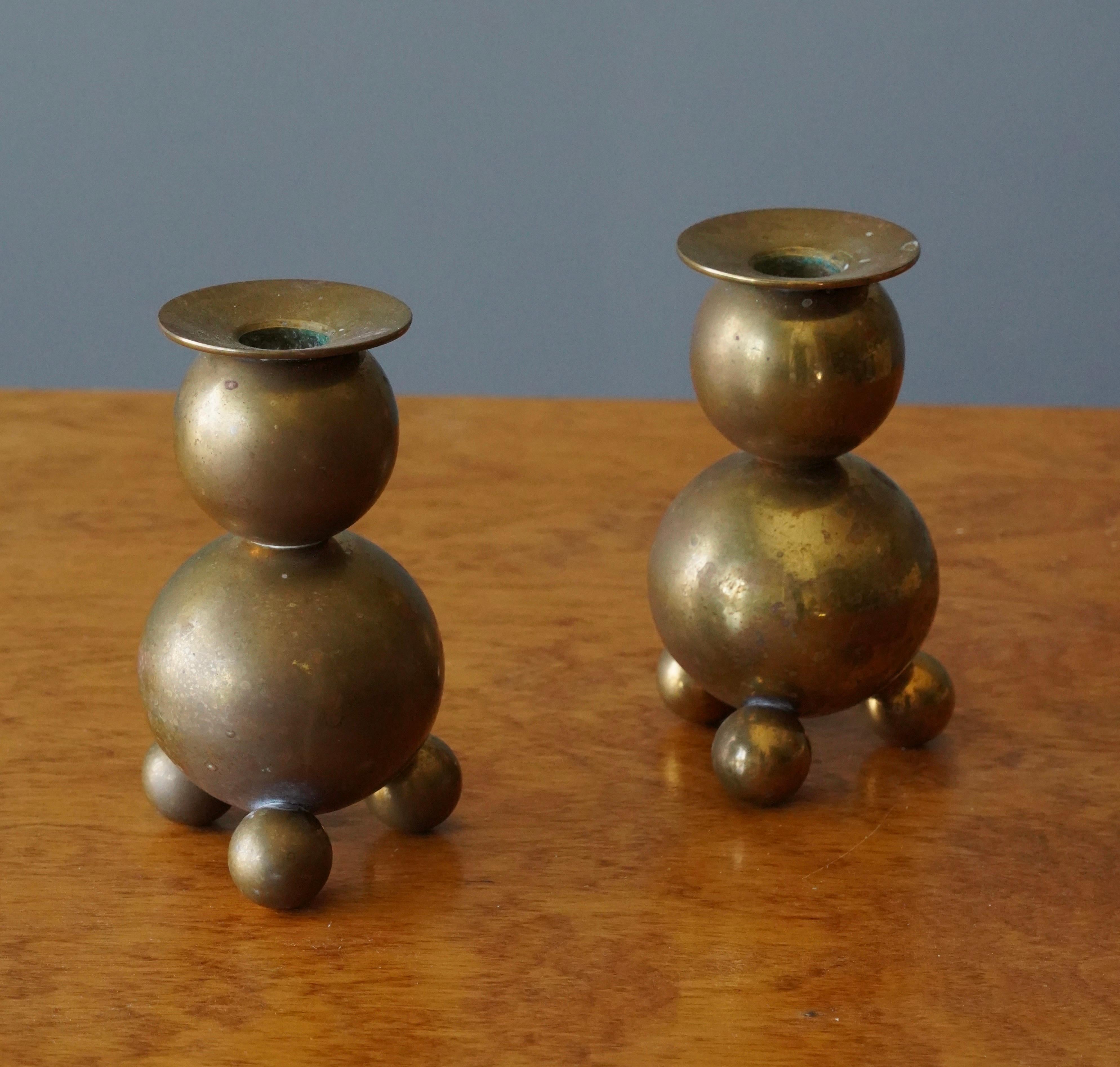 A pair of candle holders. Design and production by Metallslöjden Gusums Bruk, Sweden. In heavy alloy brass.