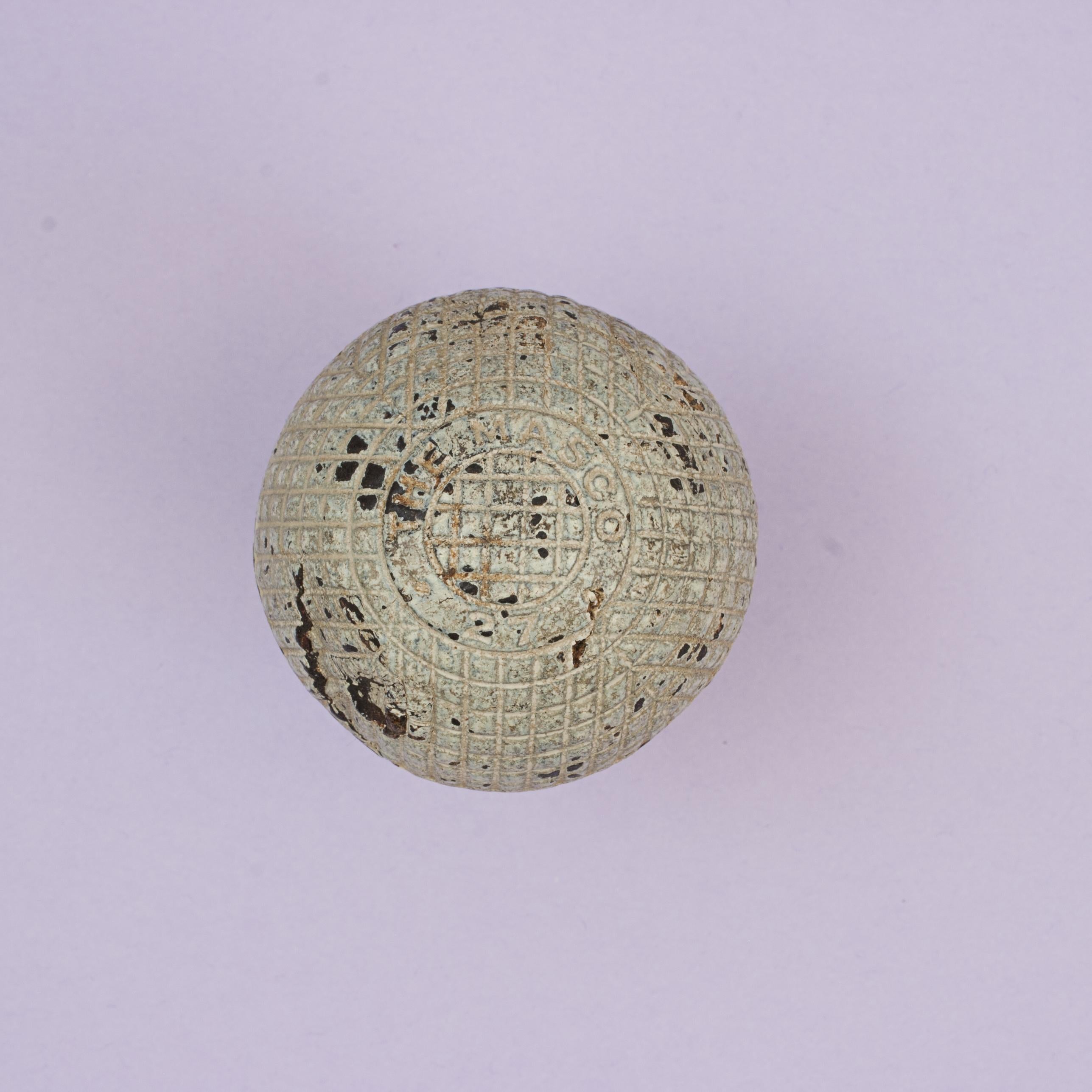 The Mascot, Antique Gutta Percha Golf Ball.
A good example of a moulded mesh patterned Victorian gutta percha golf ball. The ball is marked ''The Mascot 27' on a raised circular band on both poles of the ball and is with the classic mesh pattern.