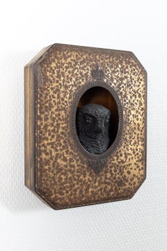 Art piece of a black owl in a tin box, called 'King'