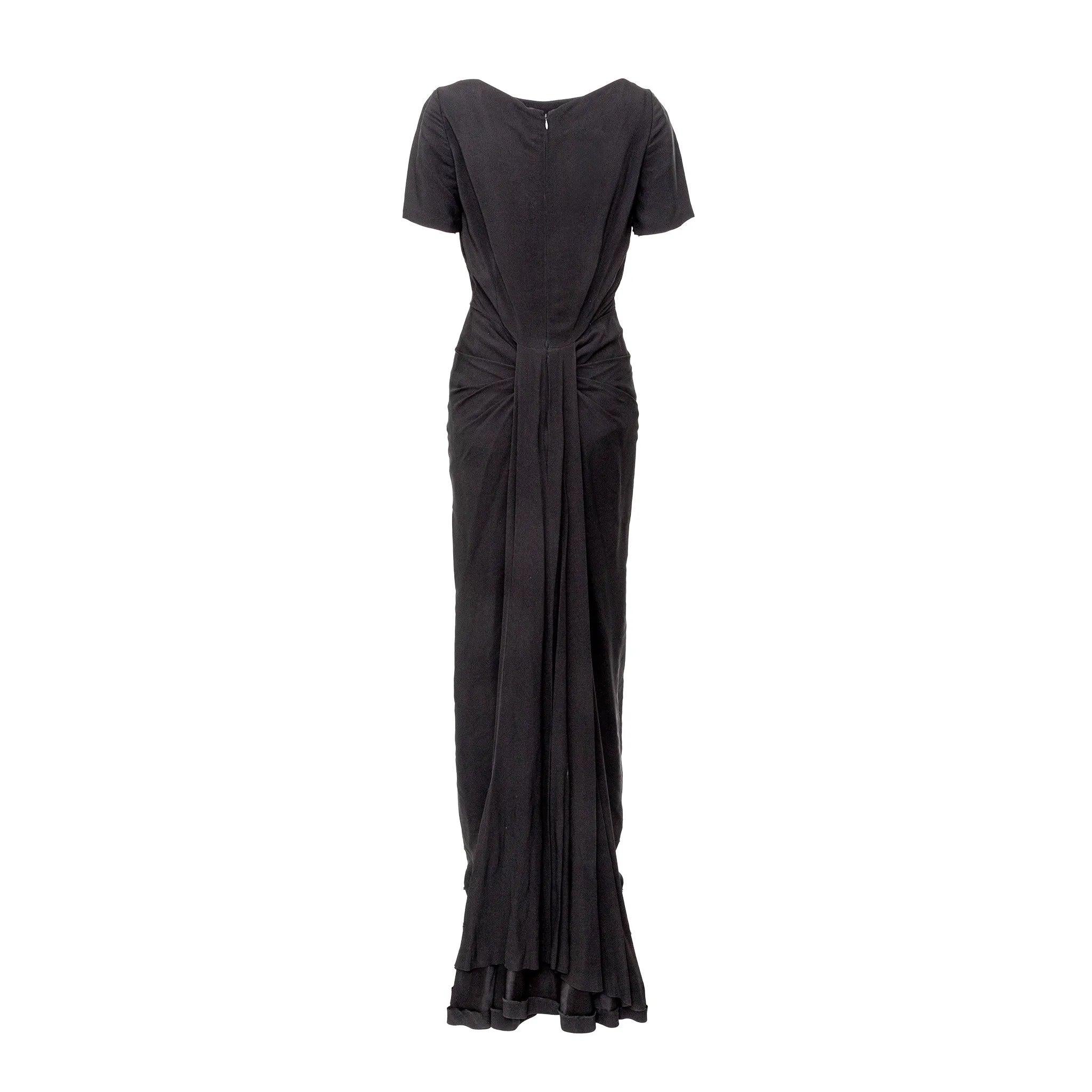 Elegantes Vintage-Couture-Kleid von Guy Laroche in zeitloser, langer schwarzer Silhouette mit Bootshalsausschnitt, kurzen Ärmeln, plissiertem, tailliertem Mieder und einer auffälligen, in Falten gelegten Schleppe, die am Rücken herabfällt - ein