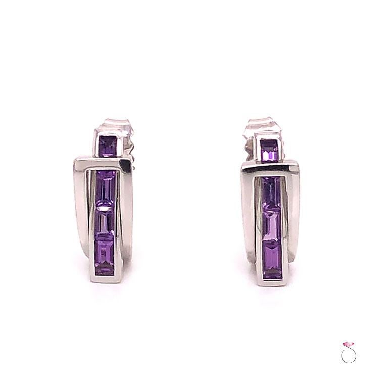 French Designer Guy Laroche Amethyst huggie earrings in 18k white gold. These earrings have a unique pass through design. The beautifully designed earrings features four (4) rectangular cut Purple Amethyst gemstones set in a channel that passes
