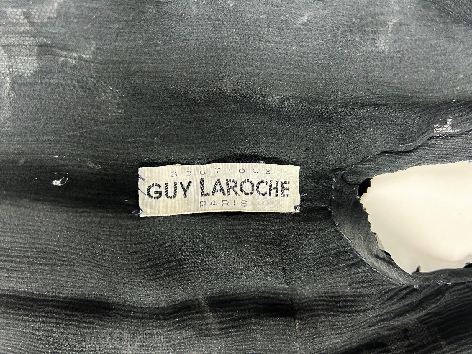 Circa 1980

France

Elegant black embroidered bolero or sleeveless evening jacket from the famous Maison Guy Laroche in Paris dating from the 1980s. Sleeveless bolero, straight cut and crew neck, black silk crepe bottom spectacularly embroidered