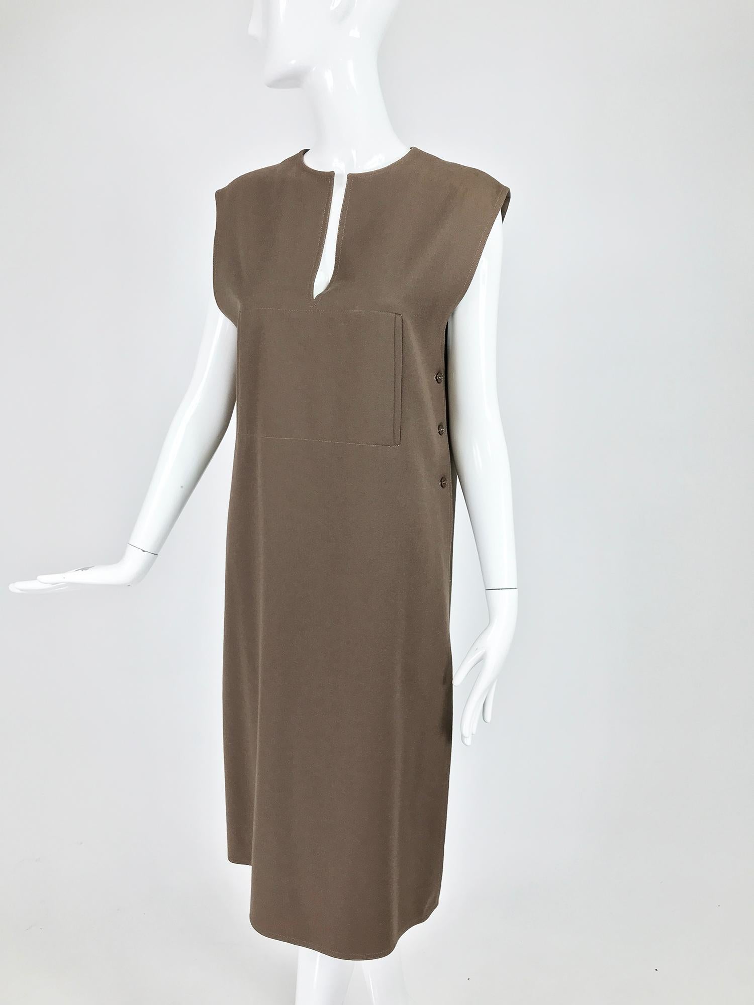 Guy Laroche ready to wear label, chocolate brown double face wool tunic dress from the 1960s.  Unique dress/tunic was originally meant to be worn over a sweater or shirt. This piece has a round neckline with a front vent. The shoulder is extended.