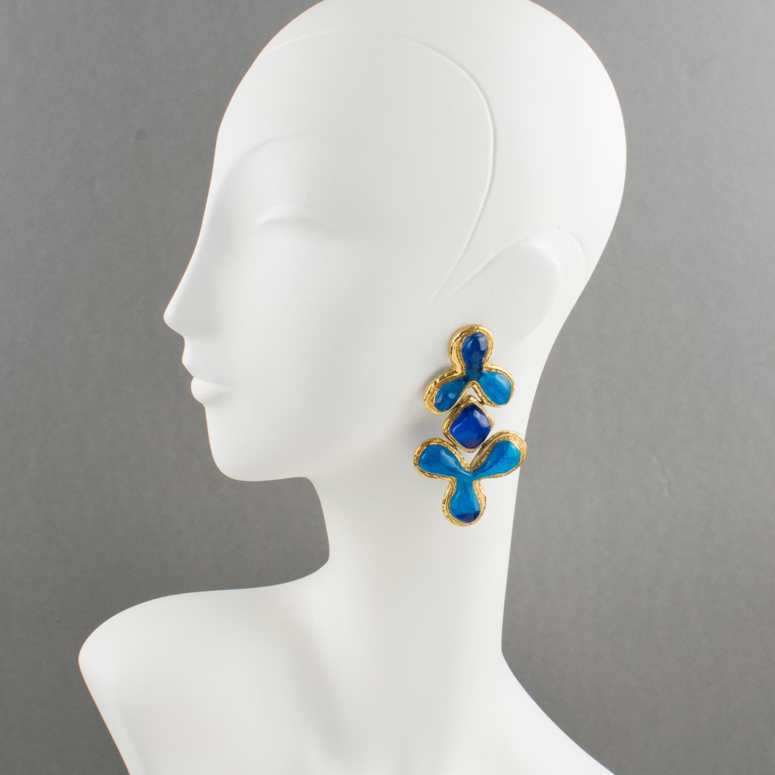 Elegant Guy Laroche Paris clip-on earrings. Dangling shape with carved and textured gilt metal framing, ornate with cobalt blue resin carved cabochons. Engraved signature at the back: 