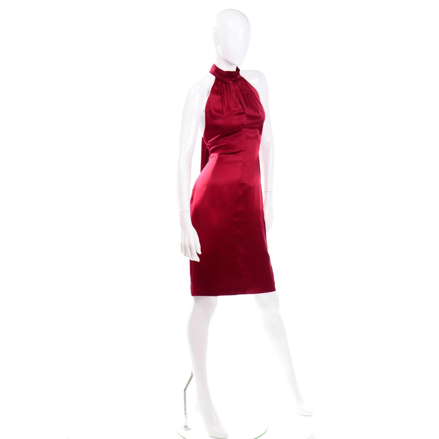 This dress is in a beautiful wine red silk charmeuse with a high pleated halter neckline.. There is a center front slit down the center of the bust and from the collar to the top of the bustline, the silk is beautifully pleated.The dress closes with