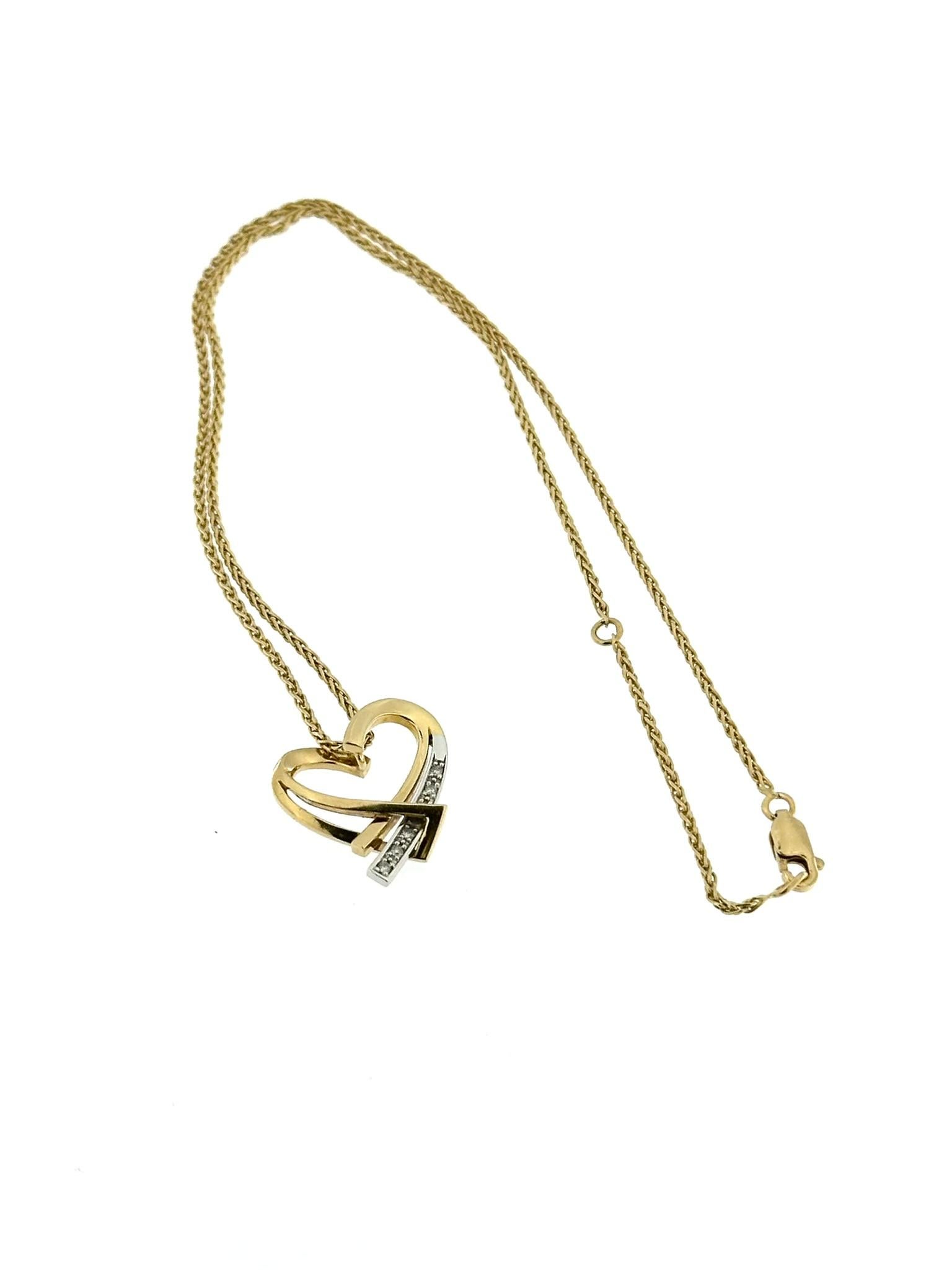 The Guy Laroche Heart Pendant with Chain is a stunning piece of jewelry designed to capture attention and evoke emotions. Crafted from 18kt yellow and white gold, this pendant embodies elegance and sophistication.

The heart-shaped design symbolizes