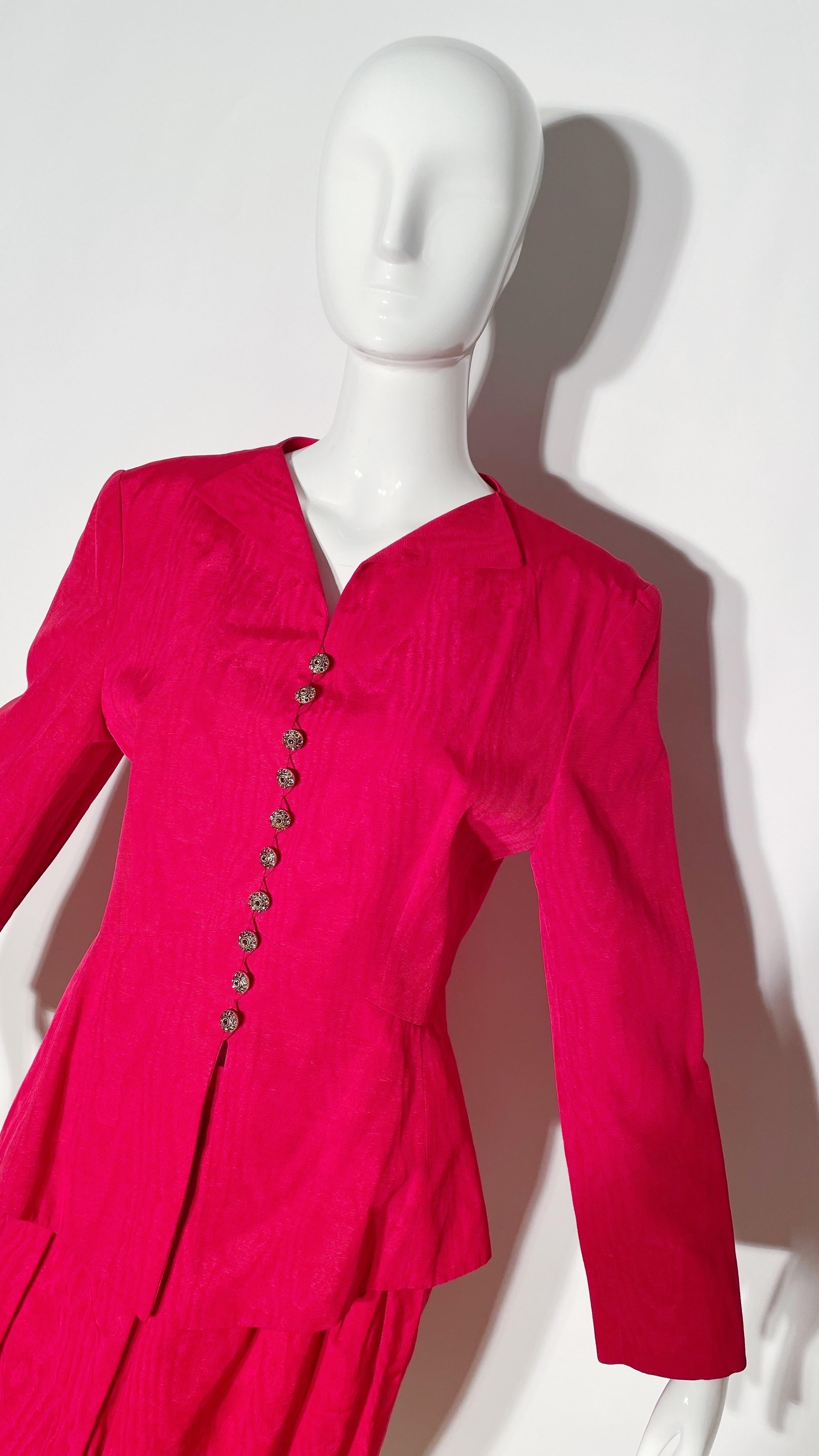 Red skirt suit. Rhinestone button detailing. Fitted. Cotton and viscose blend. Made in France. 
*Condition: Excellent vintage condition. No visible Flaws.

Measurements Taken Laying Flat (inches)—
Shoulder to Shoulder:17 in.
Sleeve Length: 23