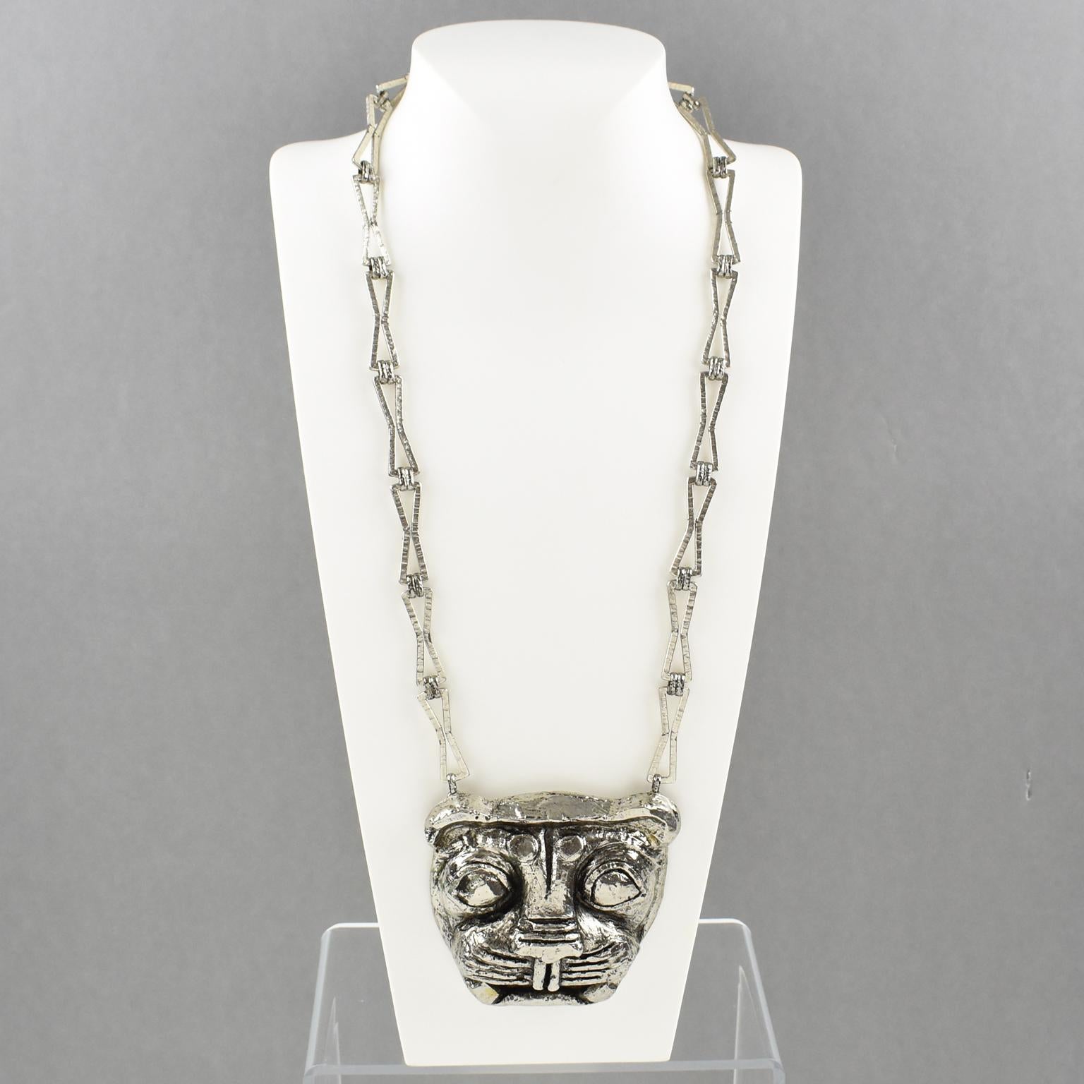 This impressive Guy Laroche Paris pendant necklace features an extra-long silvered metal textured chain with a massive dimensional pendant. The medallion boasts a lion face in silvered-metal-coated resin. There is an engraved signature on the edge
