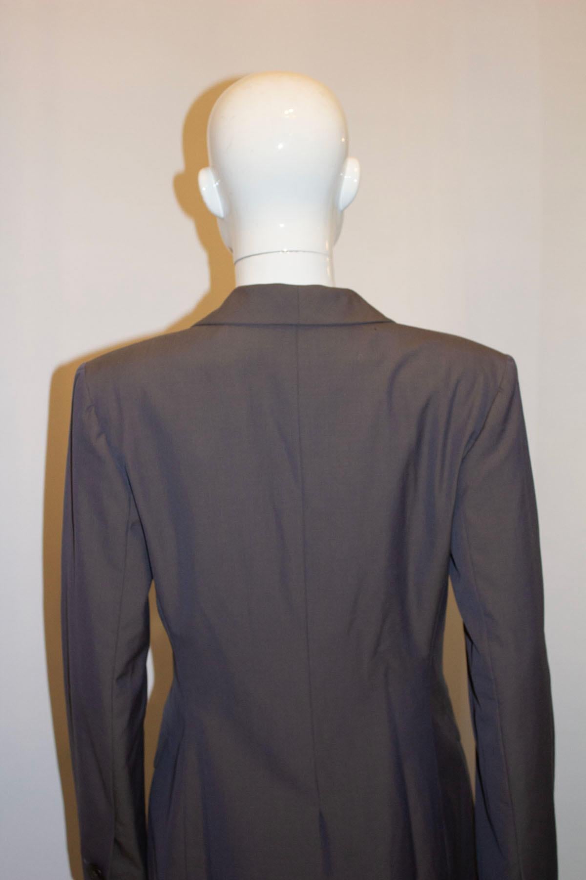 A stylish soft grey wool blazer by Guy Laroche .In a fine wool , the jacket has an interesting and unusual collar, with single button cuff detail. 
It is fully lined. EU size 40, UK size 12. 
Measurements Bust up to 36'', length 28''