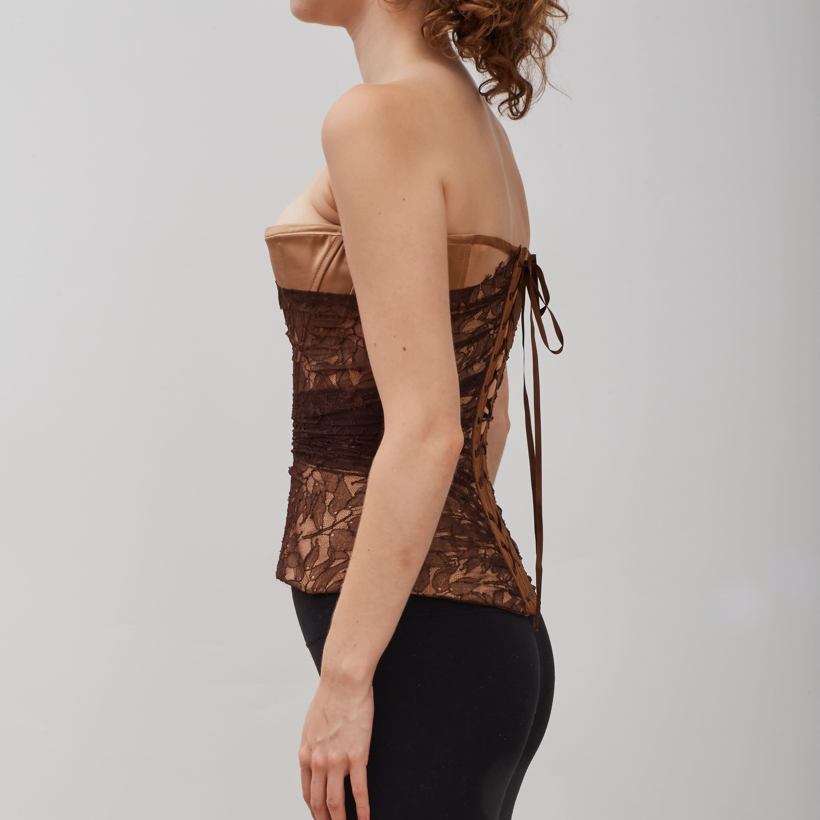 Lace up corset top by Guy Laroche featuring brown tulle lace overlay with floral embroidery. The model is wearing size 38.

COLOR: Brown lace/nude
MATERIAL: 62% polyamide, 38% viscose
CODE: 1SC913

SIZE: FR40  Medium

CONDITION: Excellent - like