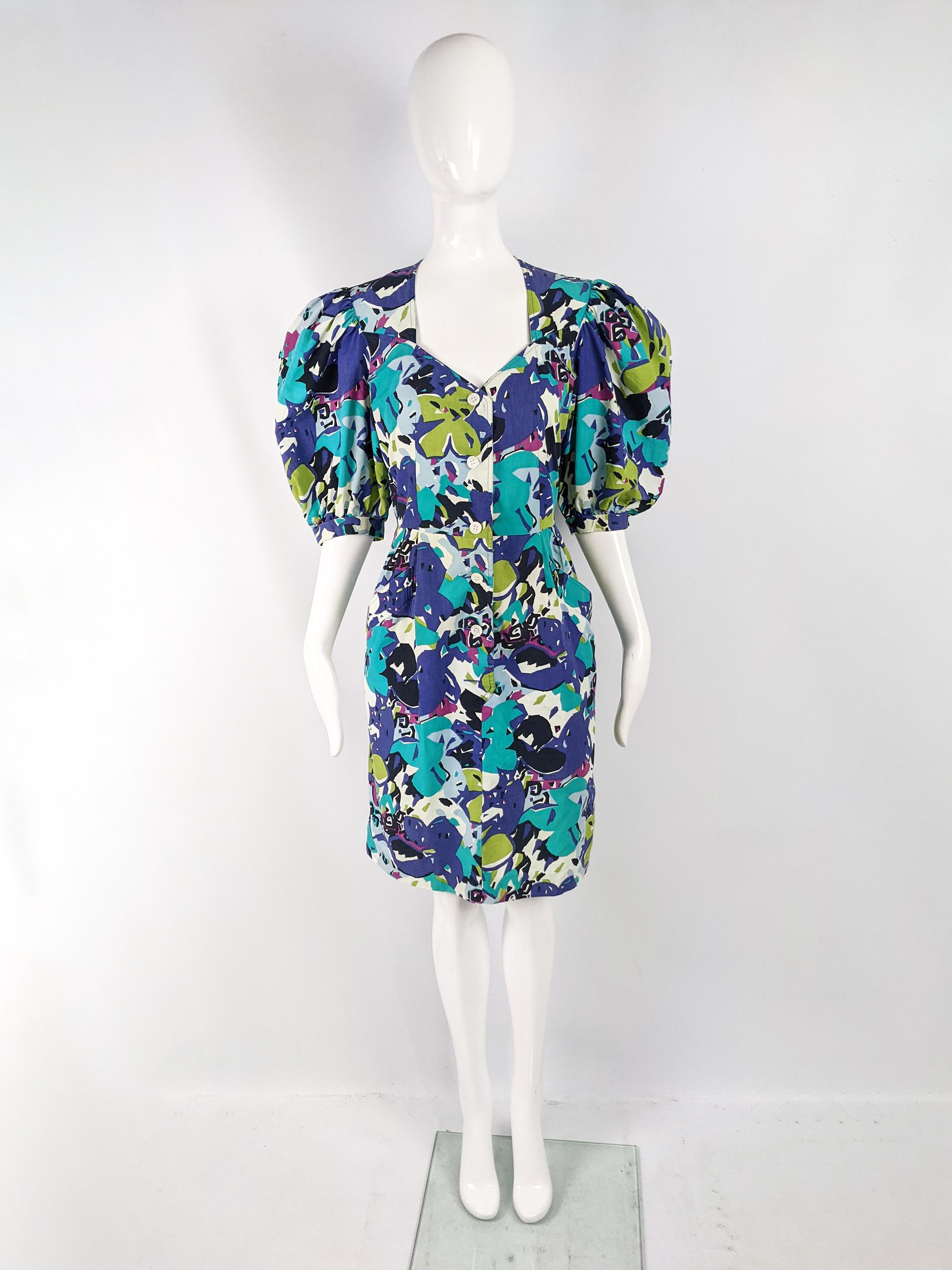 A fabulous vintage dress from the 80s by luxury French fashion designer, Guy Laroche. In a vibrantly multicoloured cotton fabric with short, puffed sleeves and a nipped waist. Perfect for a bold look in the day in spring and summer or dressed up at